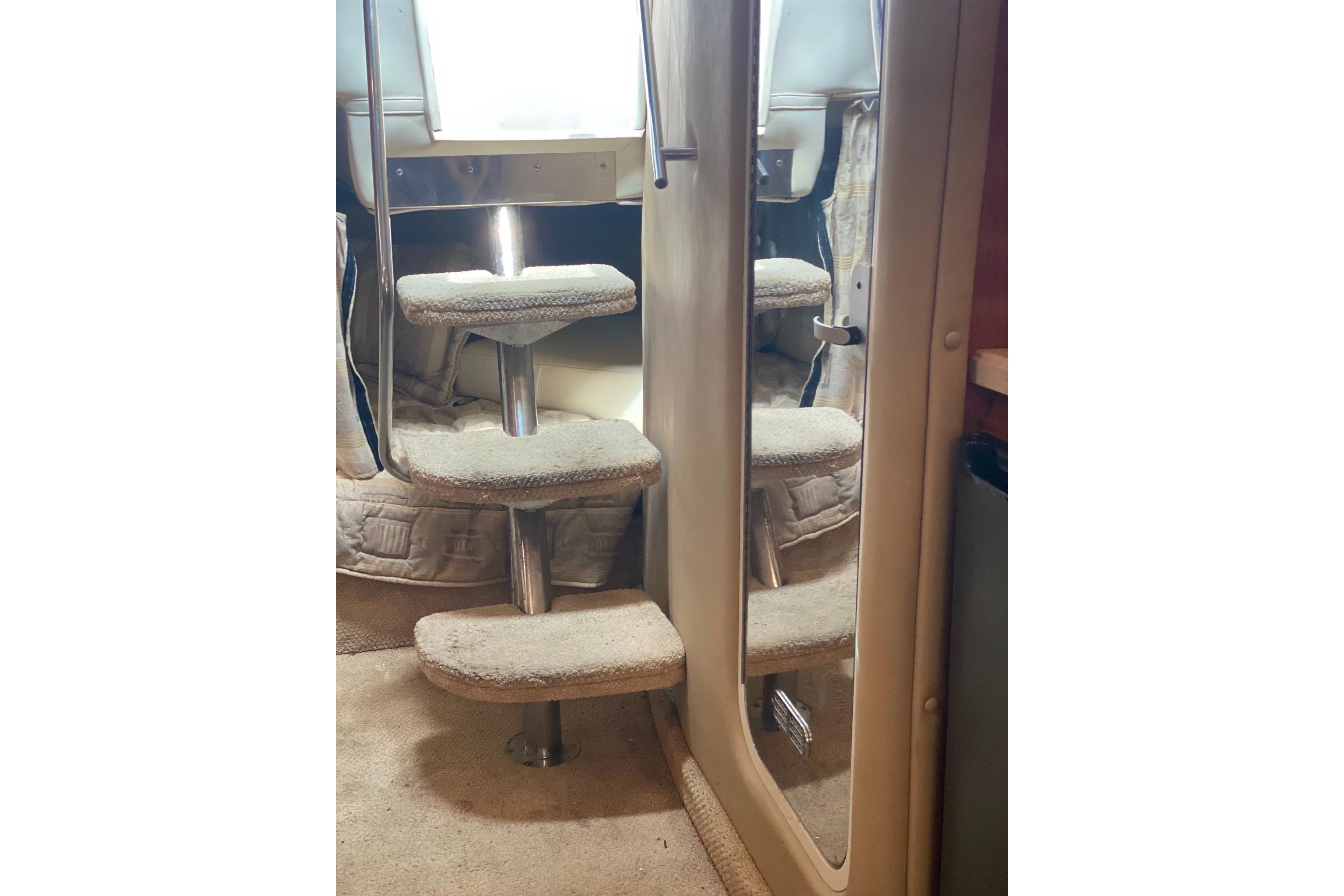 Interior stairs of 2003 Rinker Fiesta Vee 342 yacht with carpeted steps.