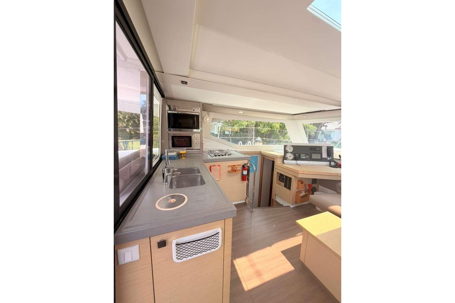Interior of 2018 Fountaine Pajot Lucia 40 catamaran, featuring modern kitchen and navigation area.