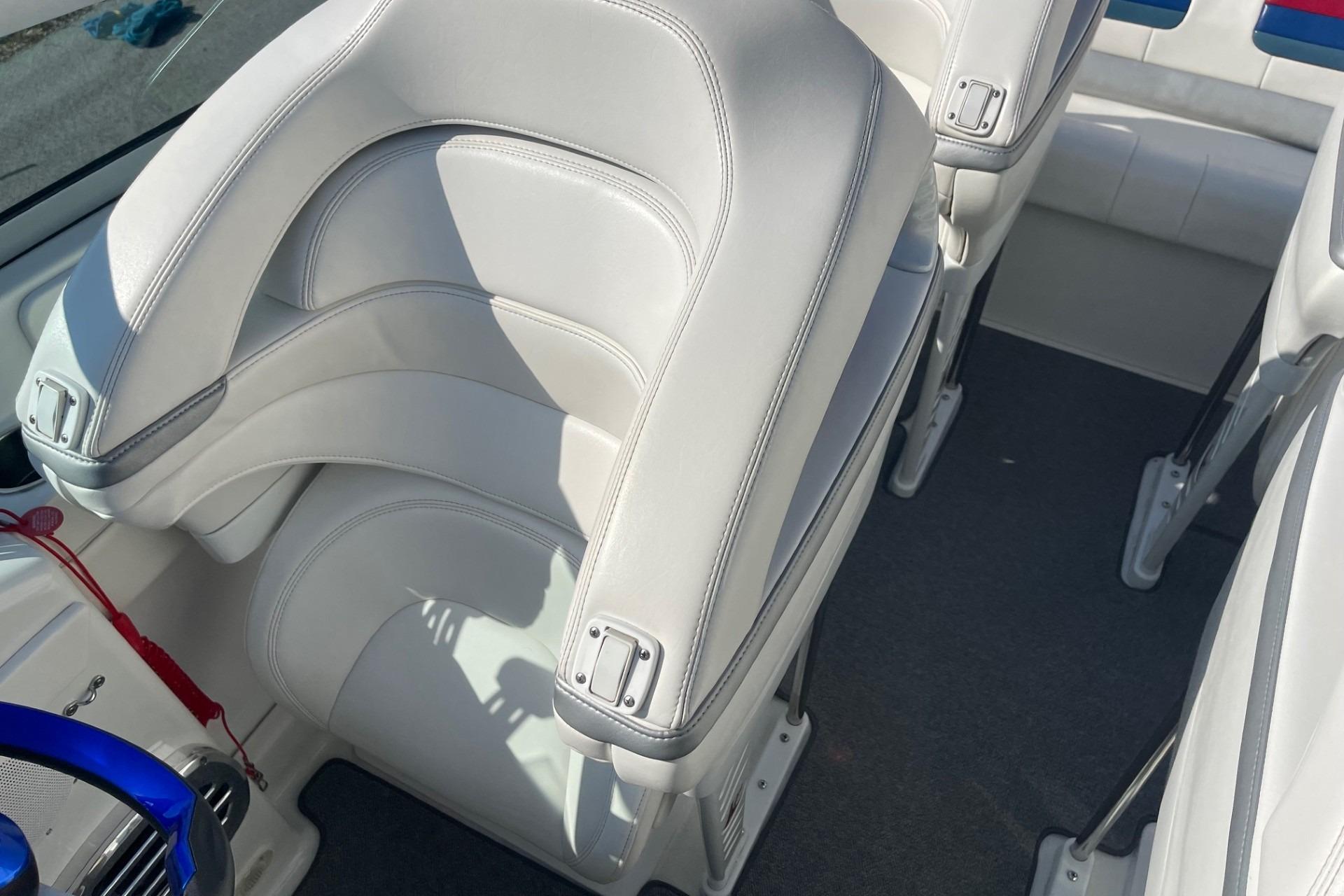 2004 Formula 382 FASTech boat interior with white leather seats and blue steering wheel.