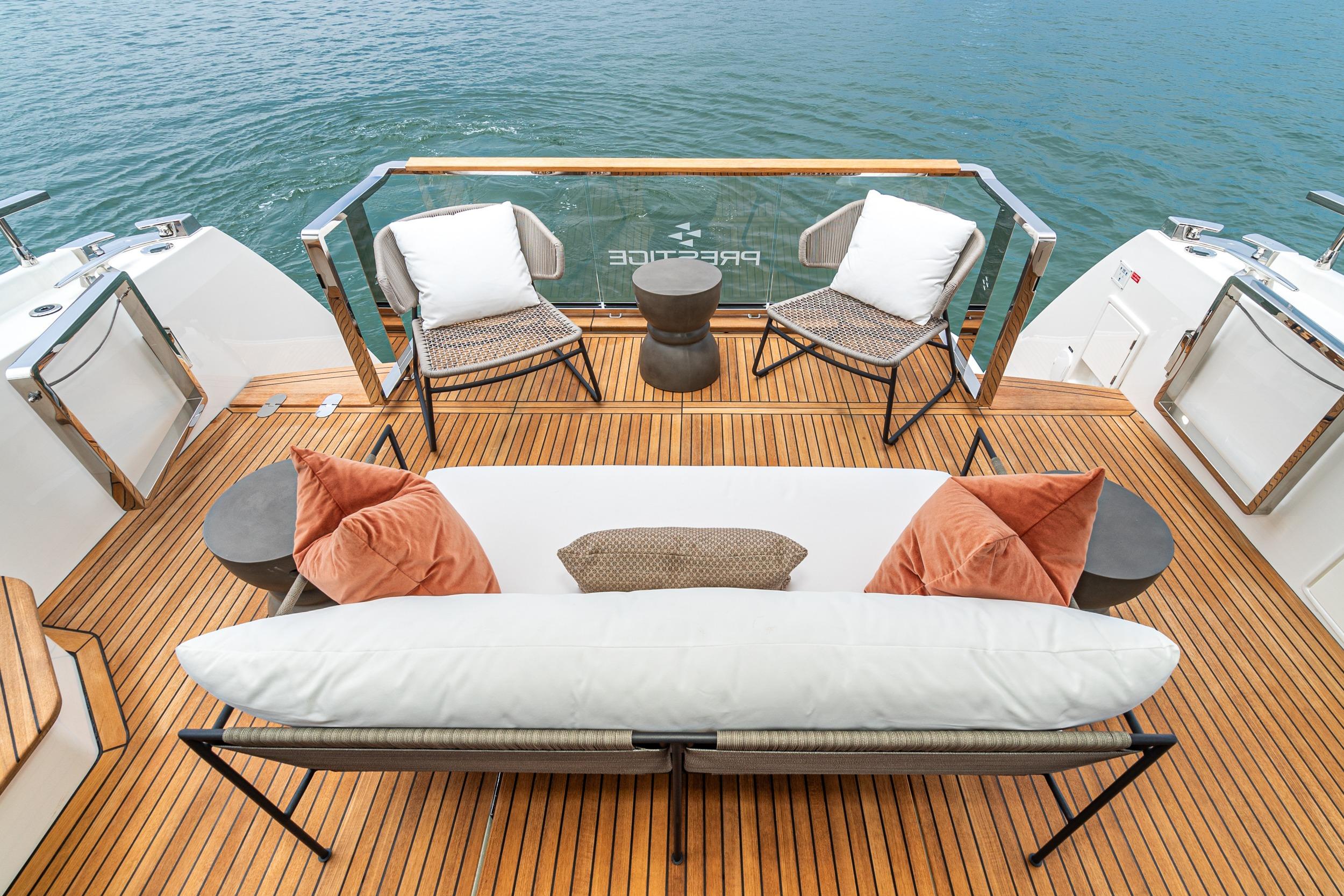 Luxurious 2024 Prestige X60 yacht deck with elegant seating and scenic water view.