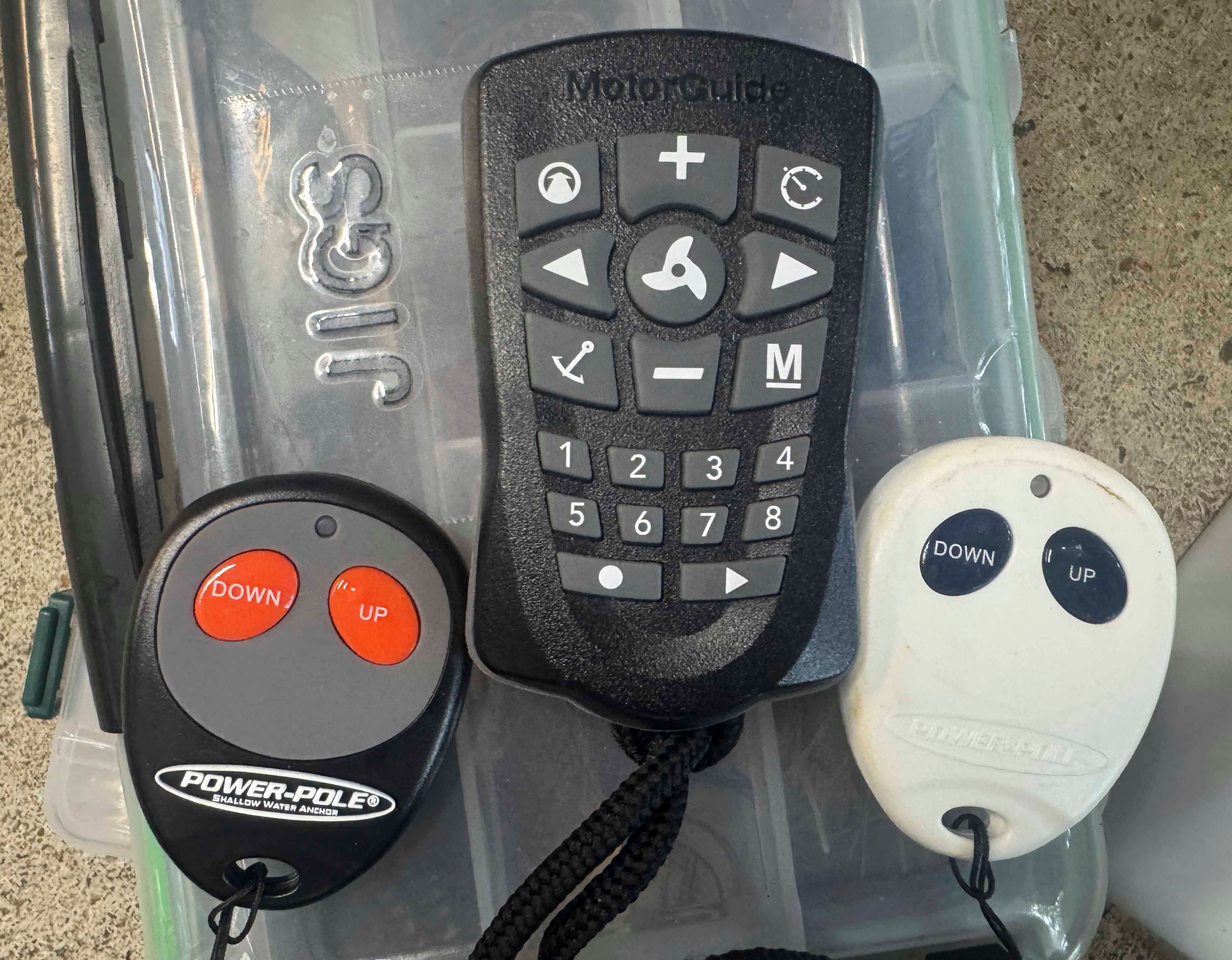 Remote controls for boat steering and anchor on a surface.
