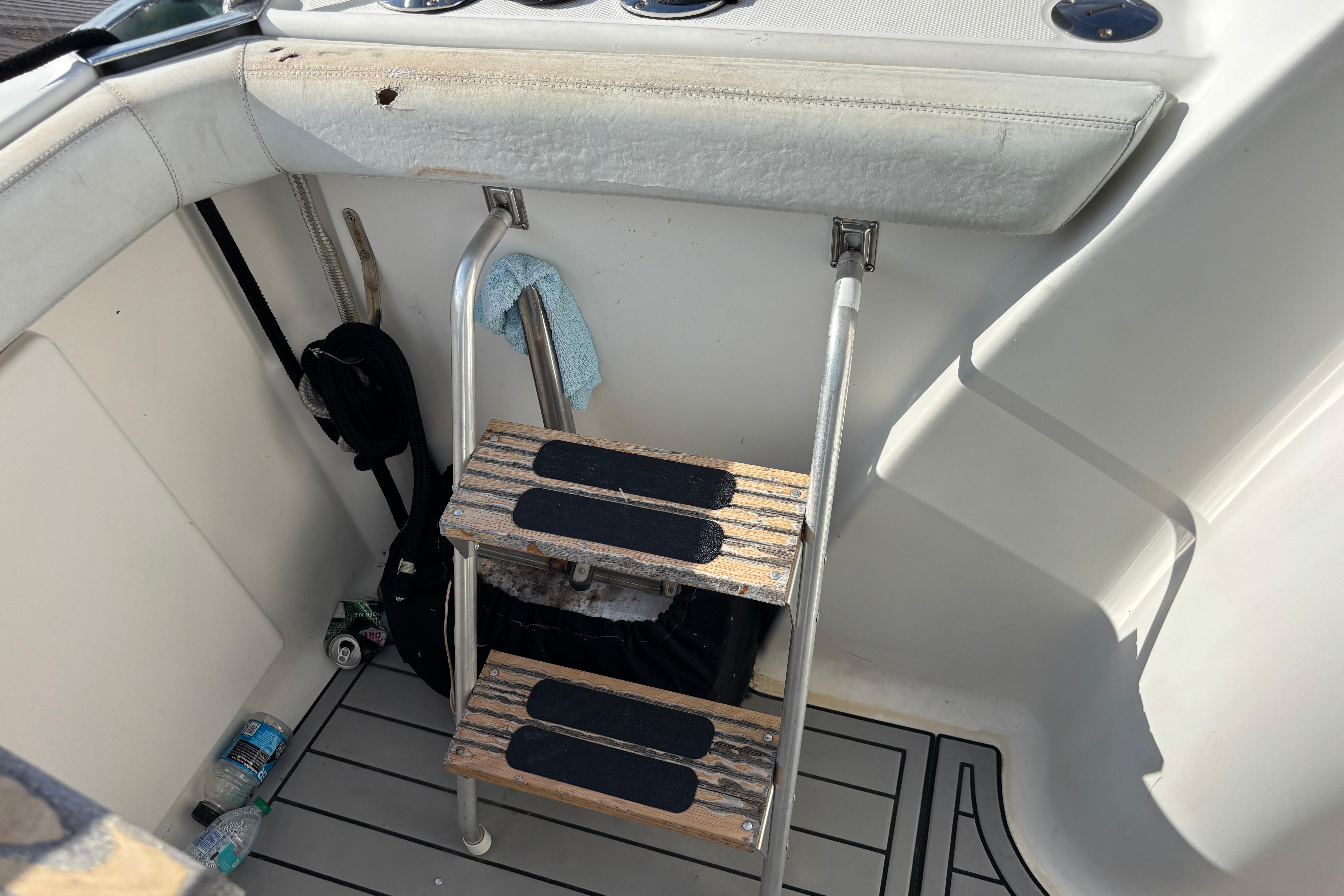 Interior of 2001 Silverton 410 Sport Bridge with wooden steps and marine accessories.