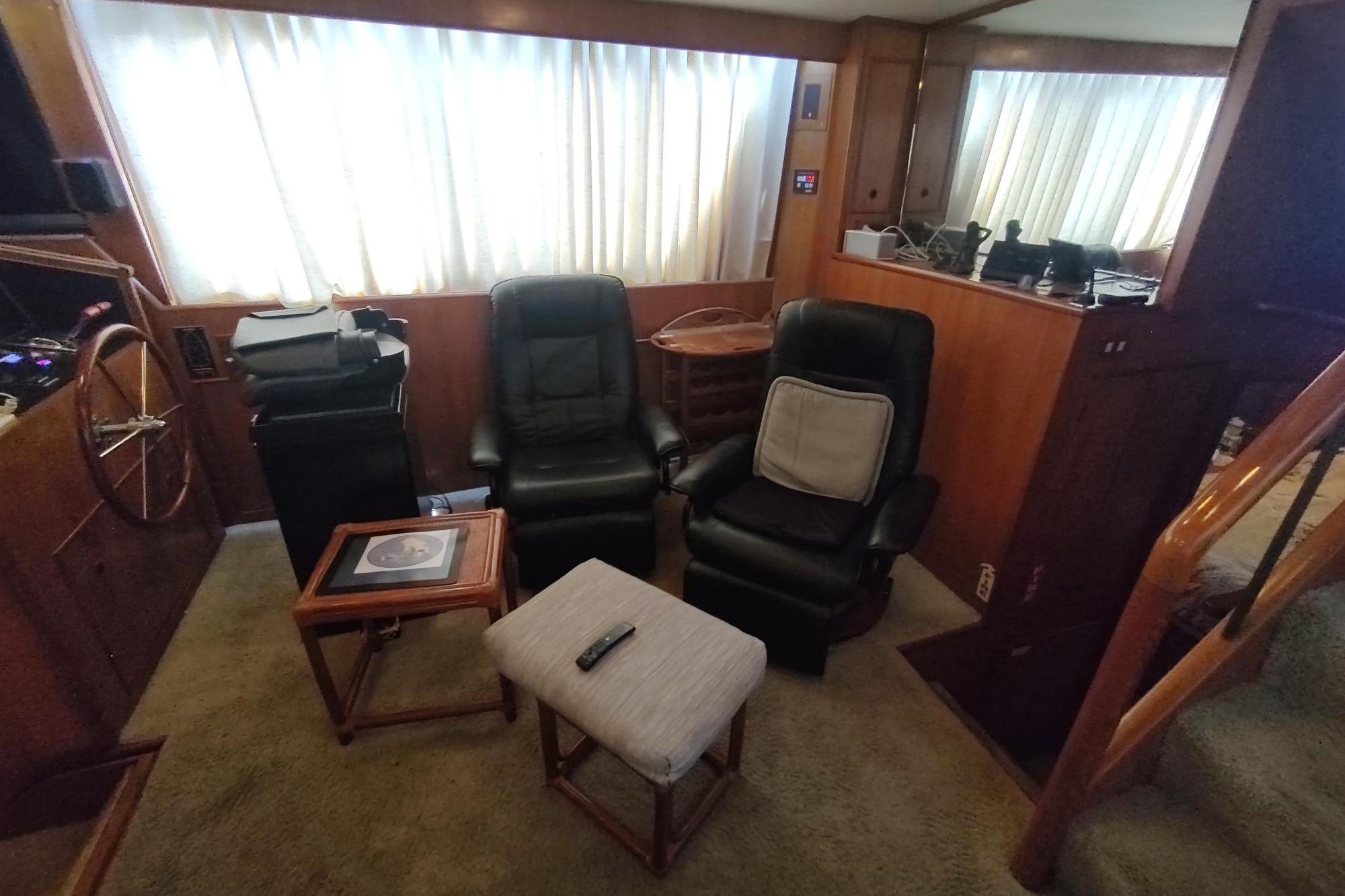 Interior of 1989 Hyatt Double Cabin Motoryacht with leather chairs and wooden accents.