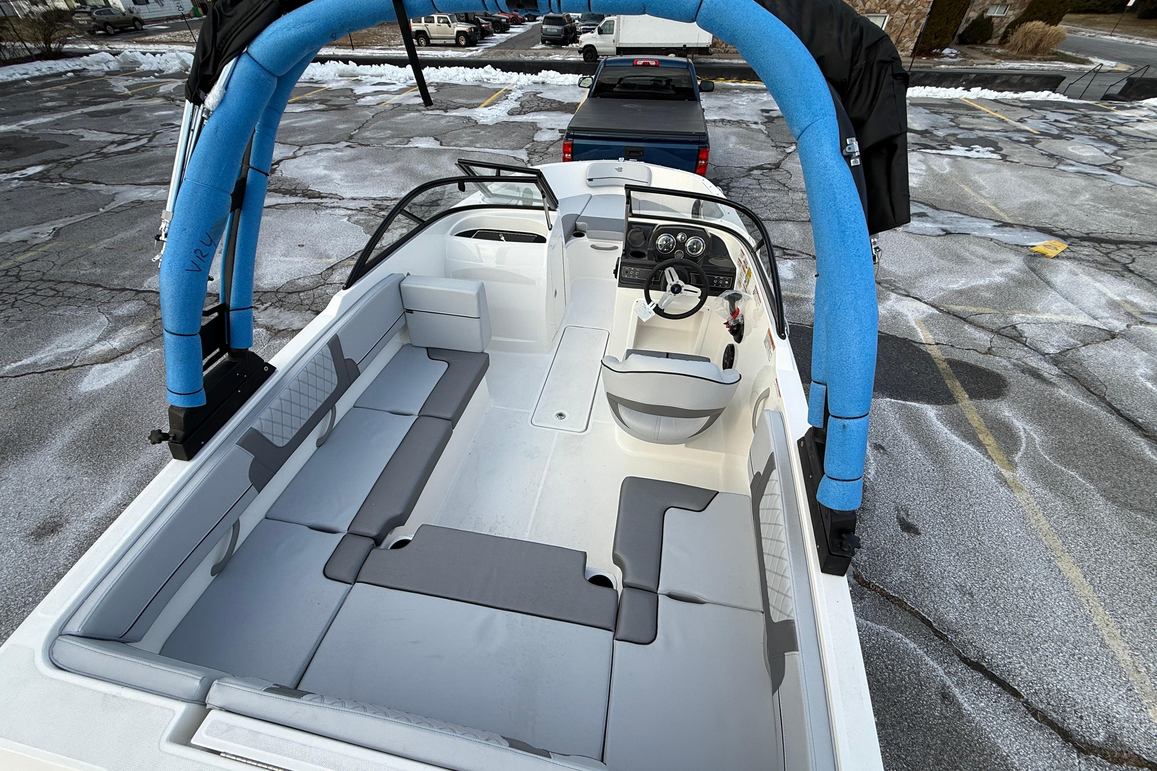 2026 Bayliner VR4 Bowrider OB with spacious seating and modern design in a parking lot.