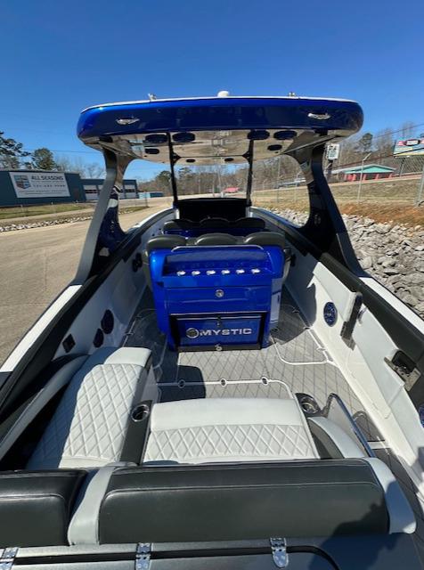 2019 Mystic Powerboats M4200 with blue accents and spacious seating on a sunny day.