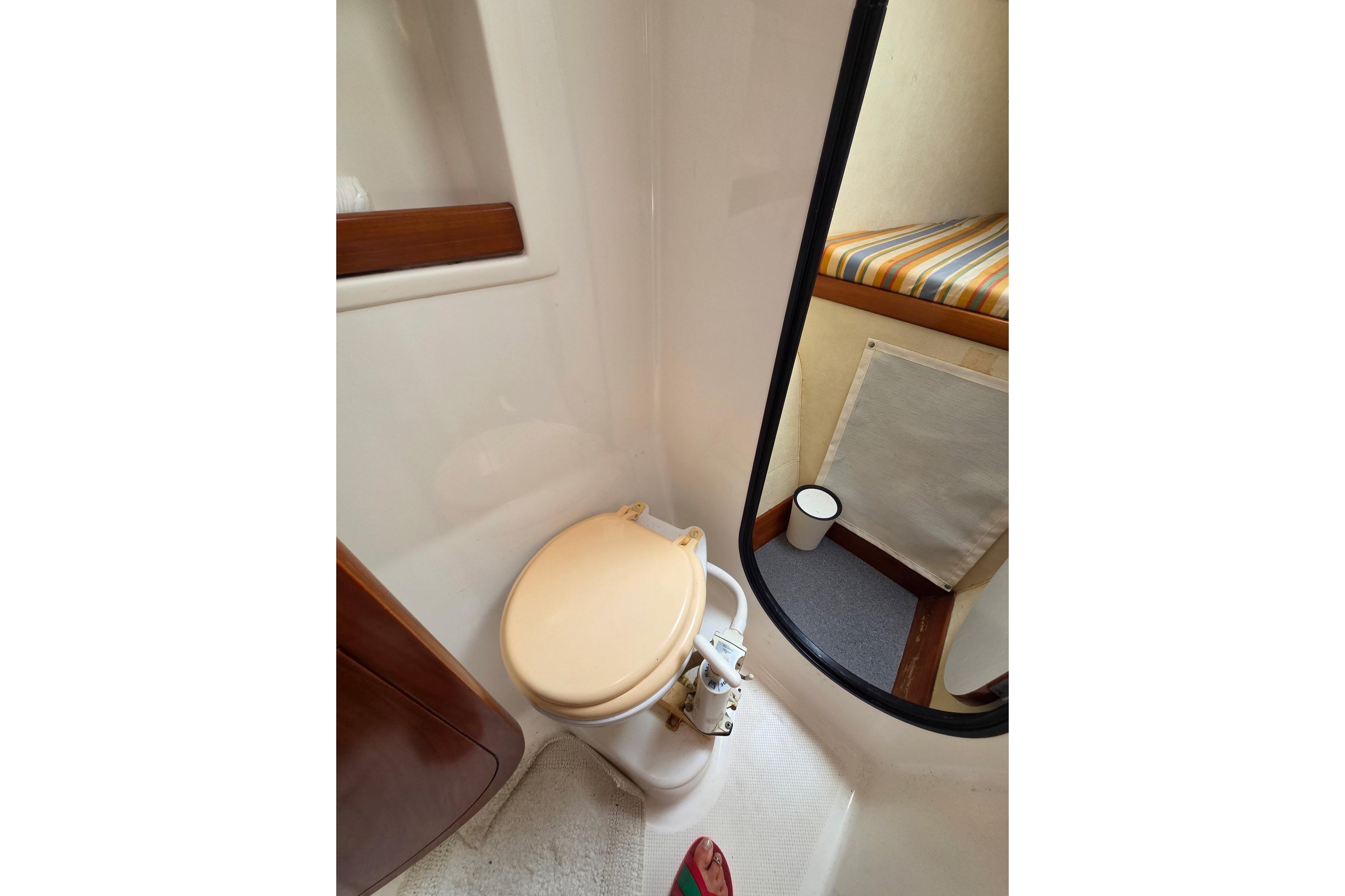 Bathroom interior of 2000 Fountaine Pajot Maryland 37 yacht, featuring a compact toilet.