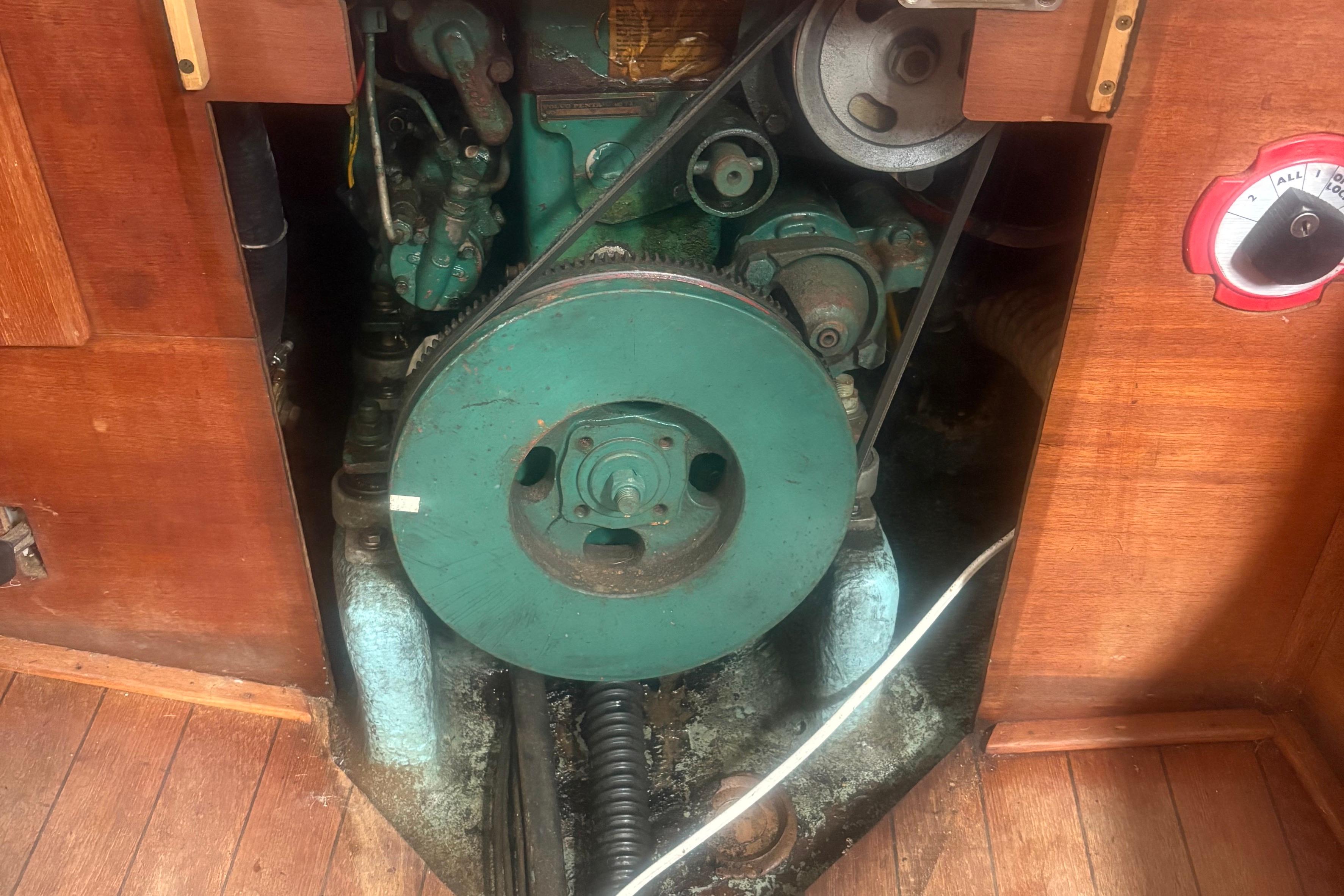 Engine compartment of a 1981 Sabre 31 sailboat, featuring a green marine engine.