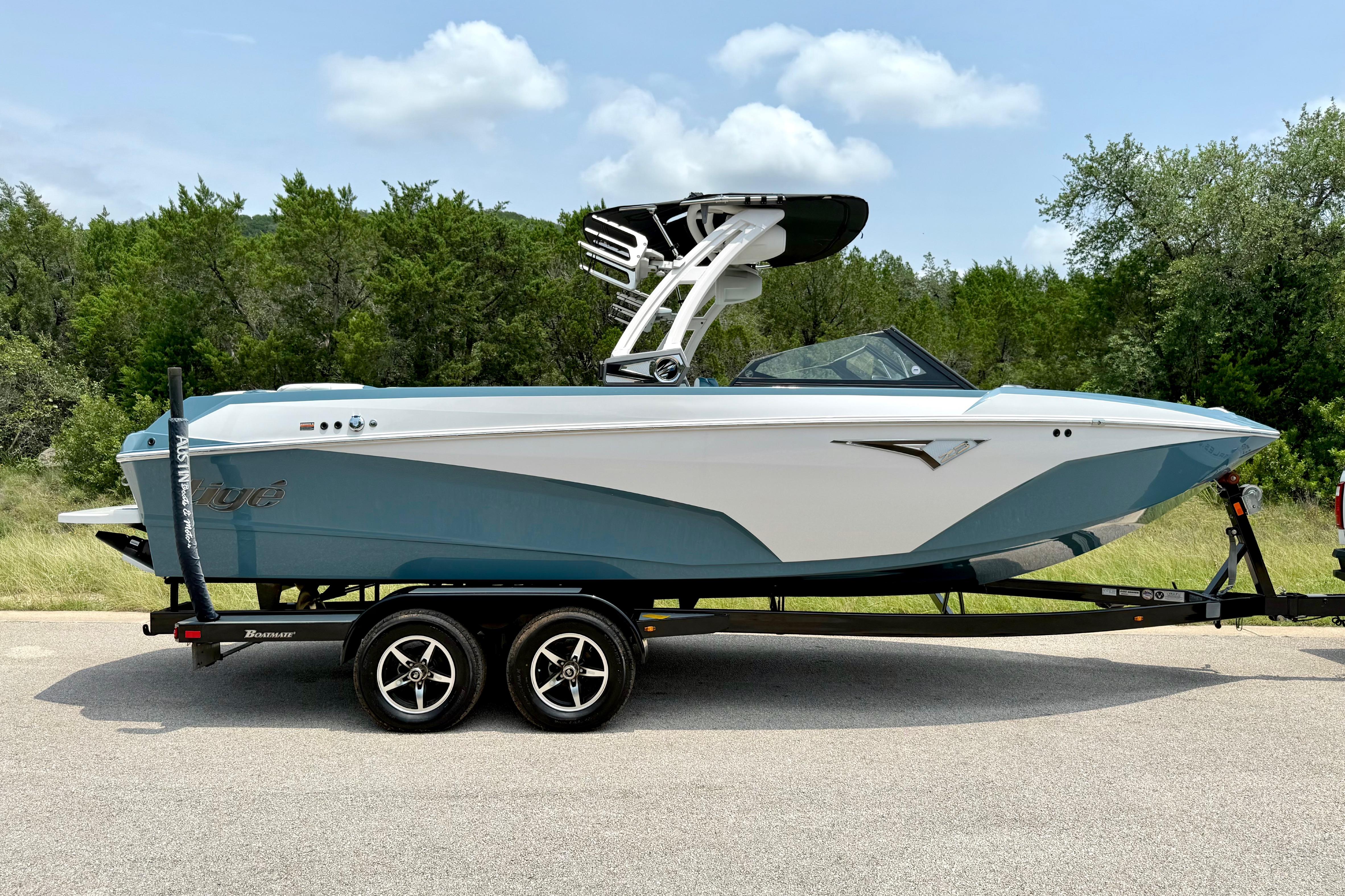 2021 Tige Z3 boat on trailer, parked on road with trees in background.
