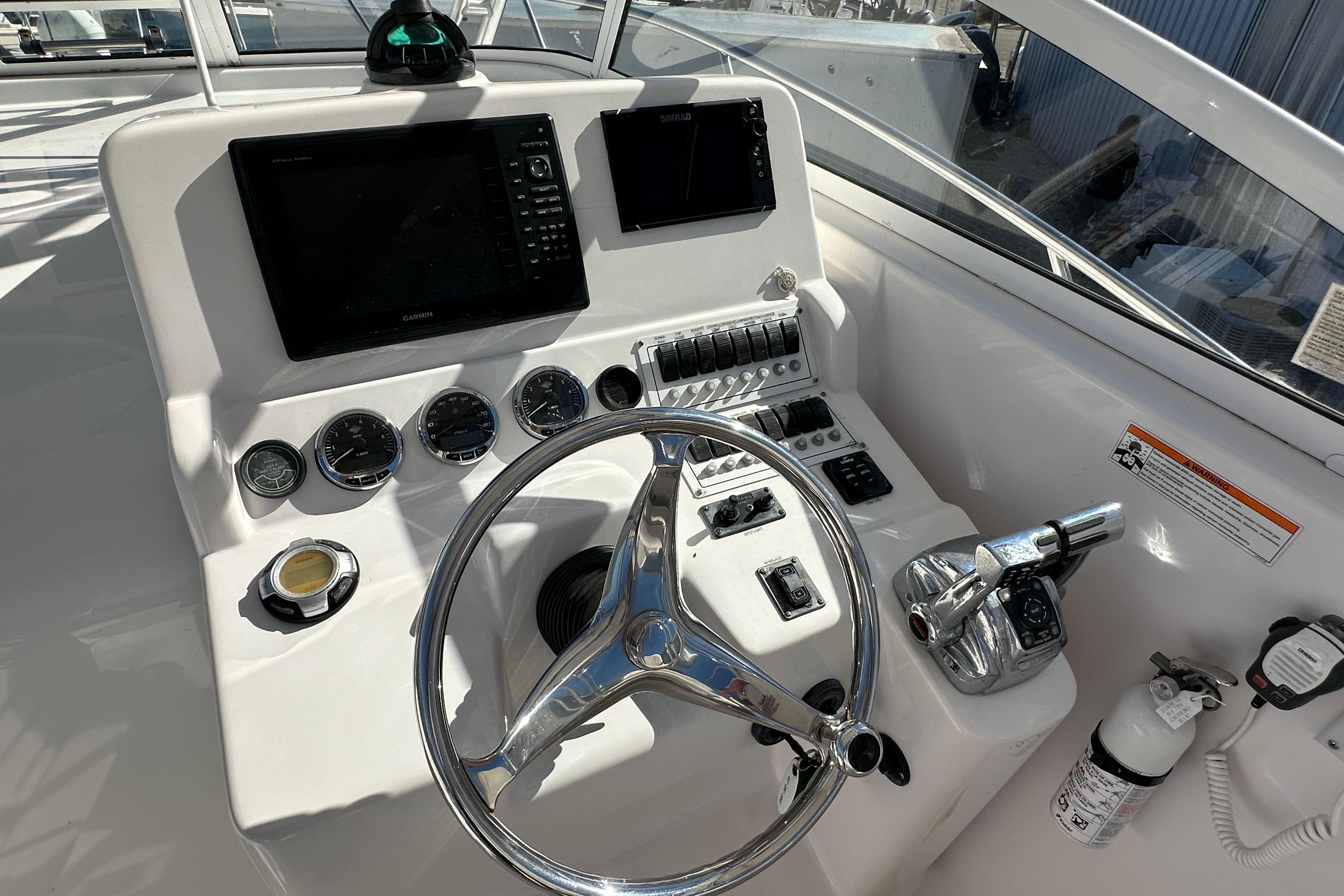 Helm of 2006 Pro-Line 32 Express boat with steering wheel and navigation controls.