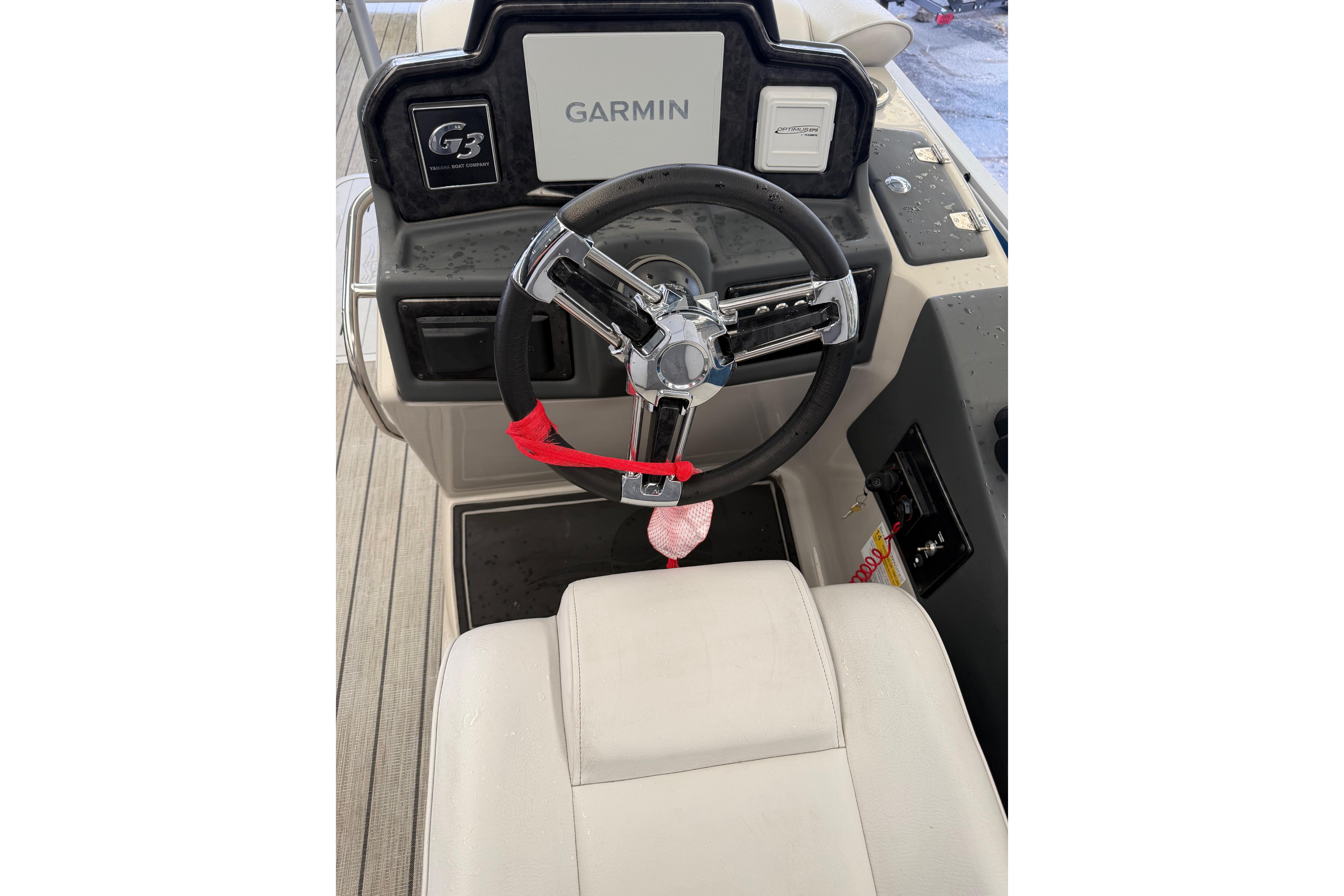 Steering console of 2024 SunCatcher Elite 326 SS DLX with Garmin navigation system.