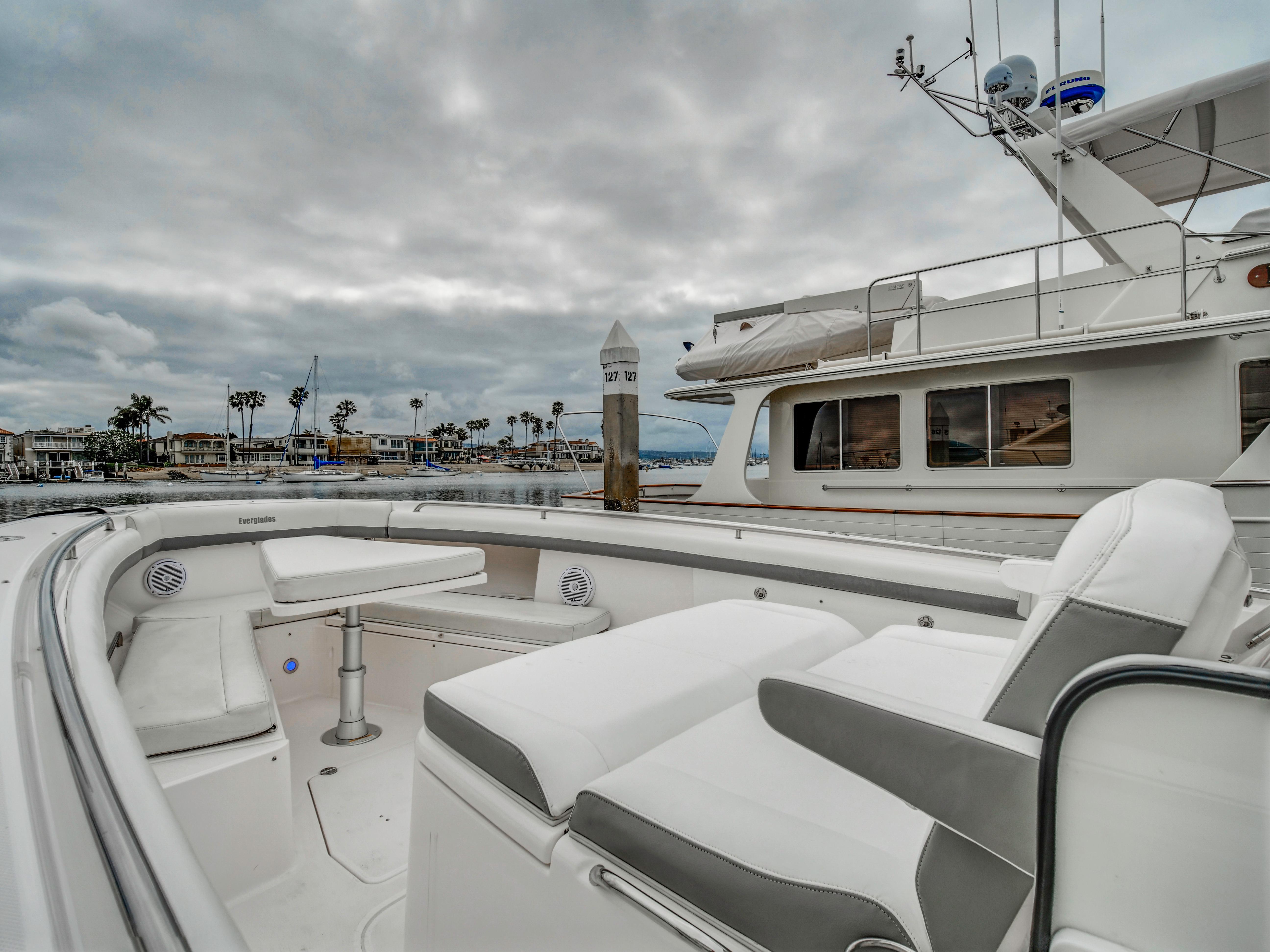 2015 Everglades 435 Center Console in harbor, cloudy sky.
