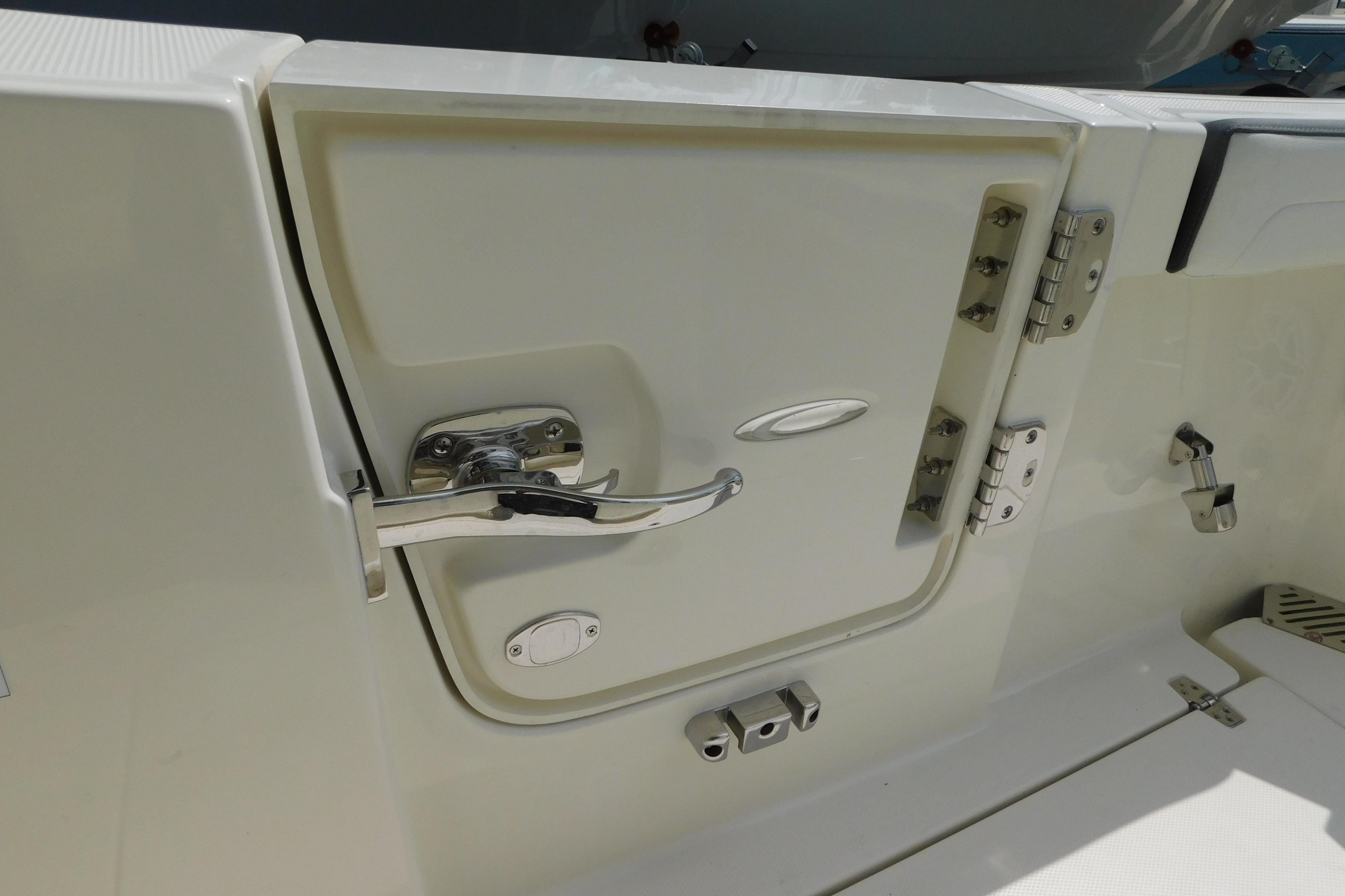2026 Cobia 245 Center Console boat door with stainless steel hardware.