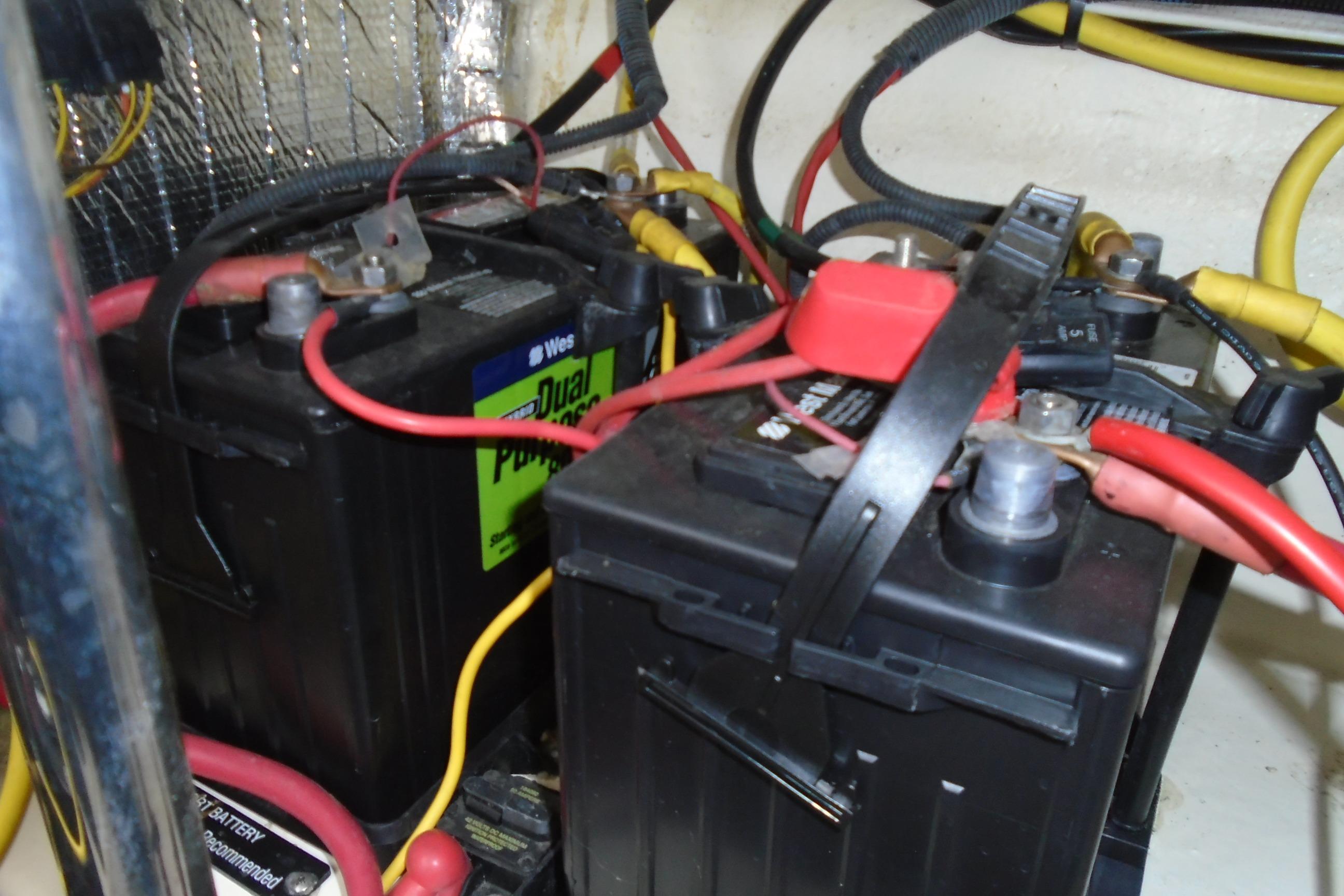 Batteries in 2013 Chaparral 327 SSX boat engine compartment with wiring connections.