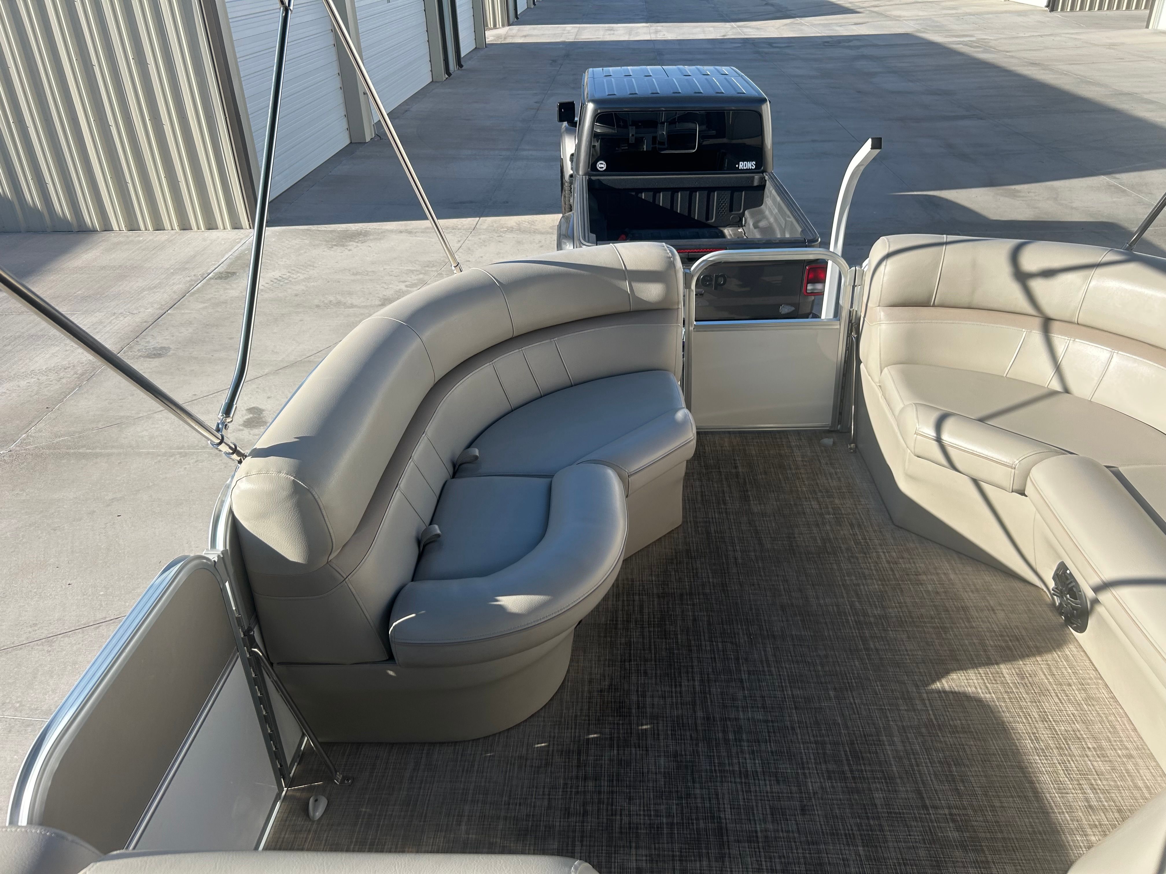The image shows the interior of a 2018 Berkshire 24RFX CTS pontoon boat with beige seating.