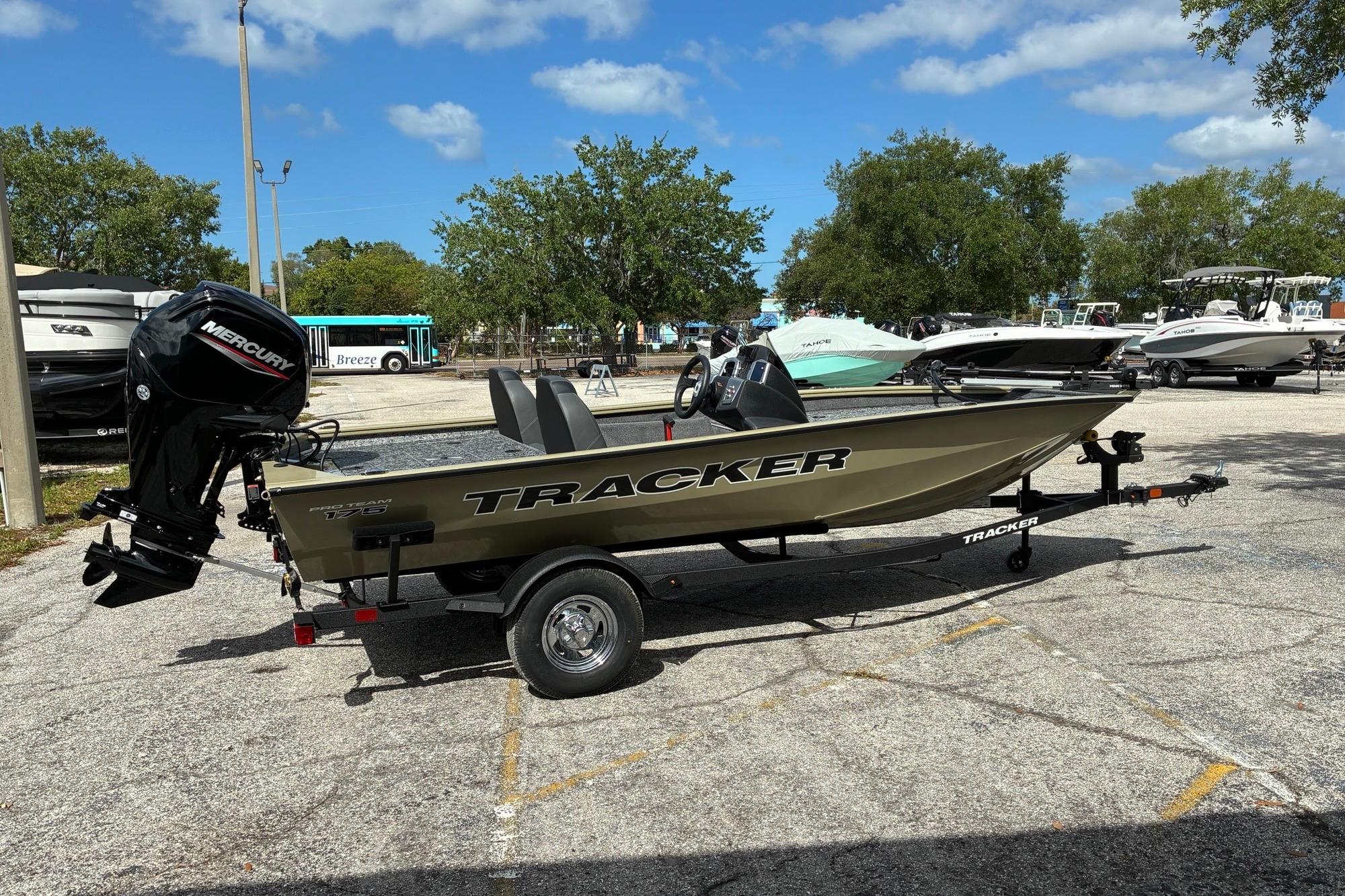 2026 Tracker Pro Team 175 boat with Mercury engine in a parking lot.