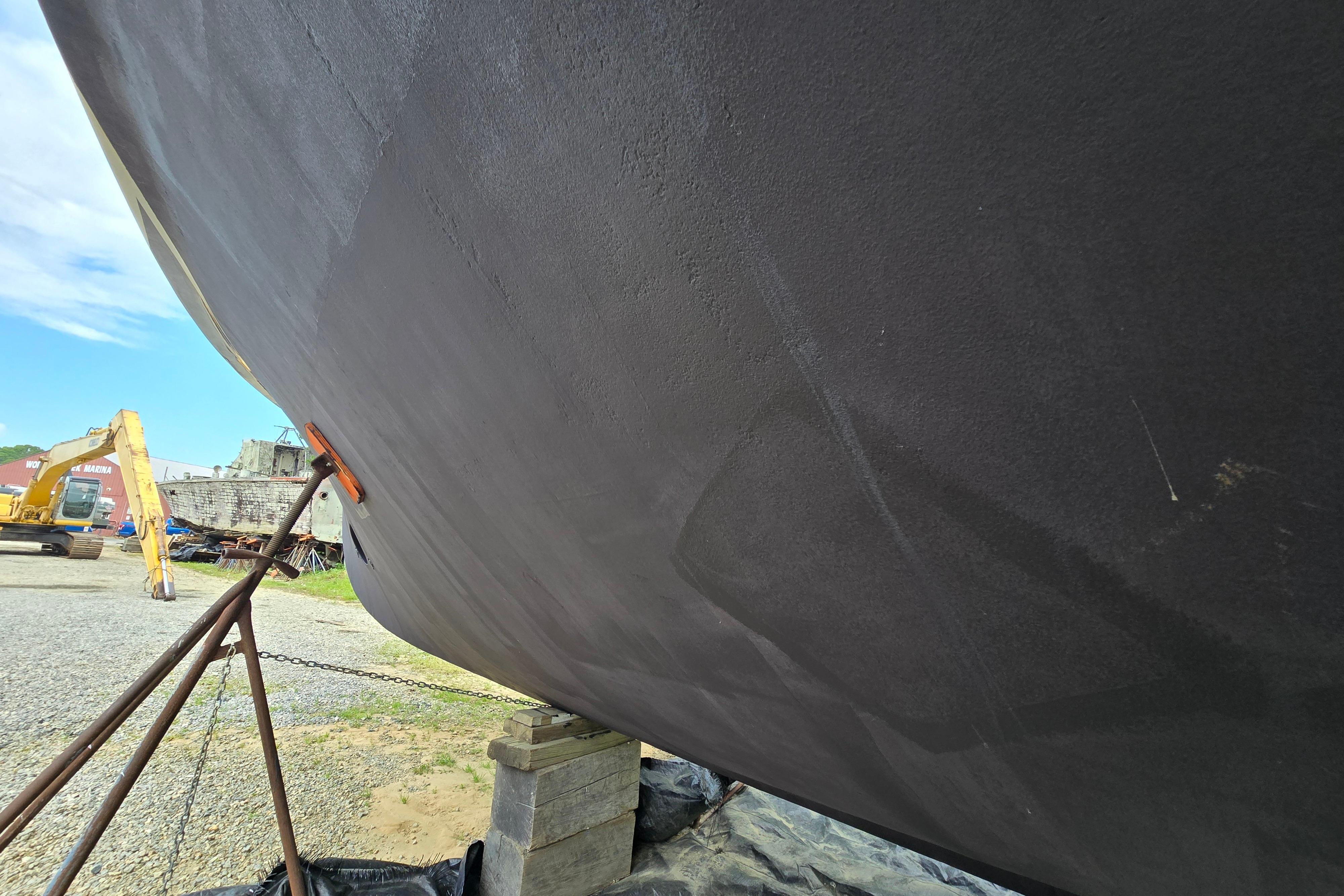 Bottom view of a 1980 Hatteras 70 Motor Yacht on dry dock.