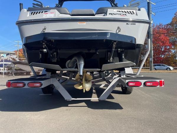 2025 Moomba Mondo boat rear view with trailer, showcasing propeller and hull design.