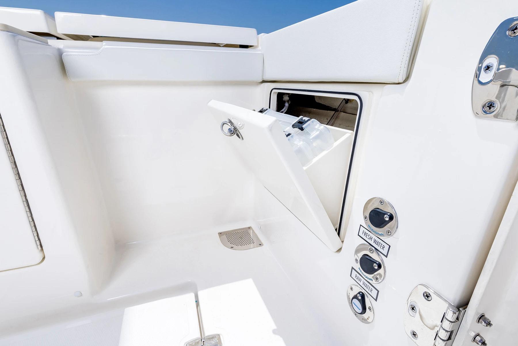 Manufacturer Provided Image: 2025 Pursuit OS 445 Offshore boat compartment with fresh and raw water controls.