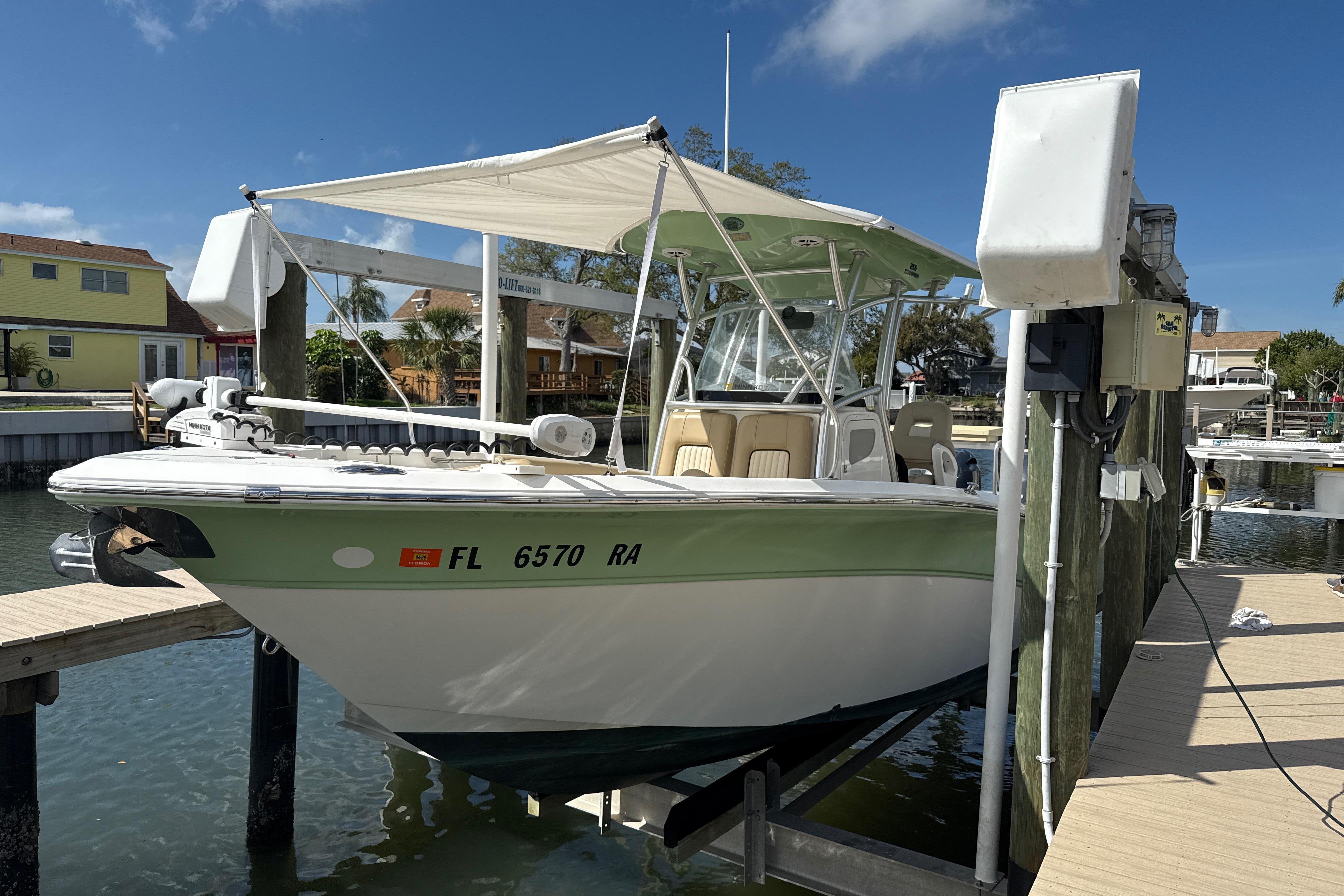 2016 Sea Fox 266 Commander boat docked at marina under clear blue sky.