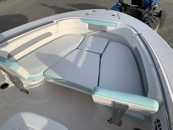 2024 Robalo R202 Explorer boat with cushioned seating area.