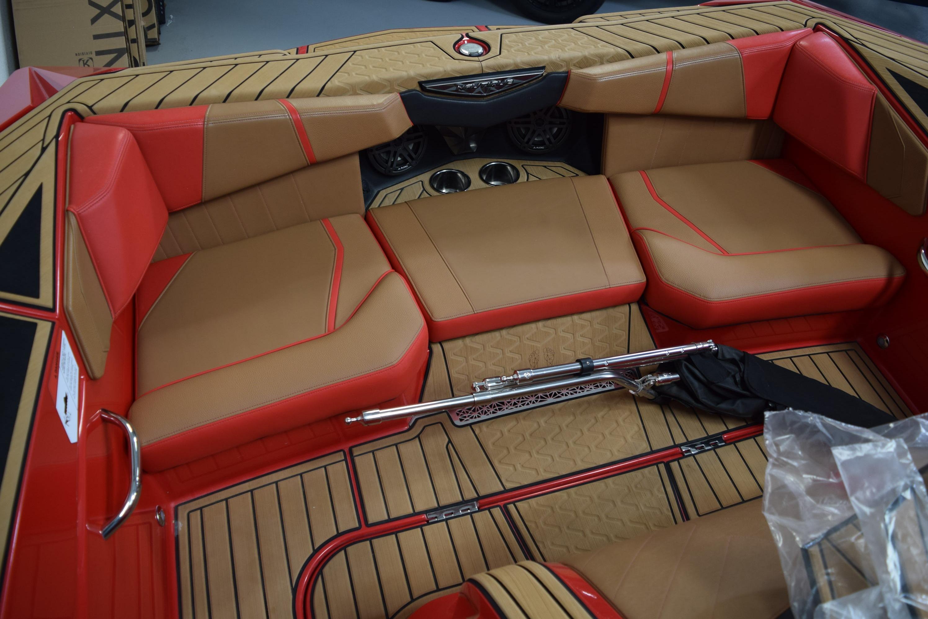 2024 Nautique Ski Nautique interior with tan and red seating, featuring sleek design elements.