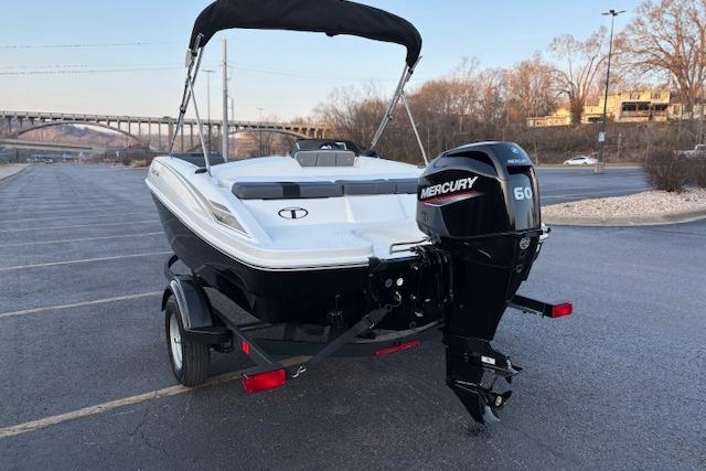 2026 Tahoe T16 boat with Mercury 60 engine on trailer in parking lot.