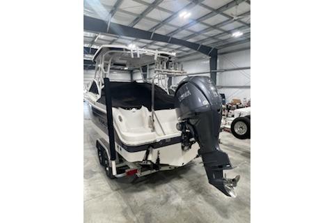 2022 Robalo R247 Dual Console boat in storage, featuring a powerful outboard motor.