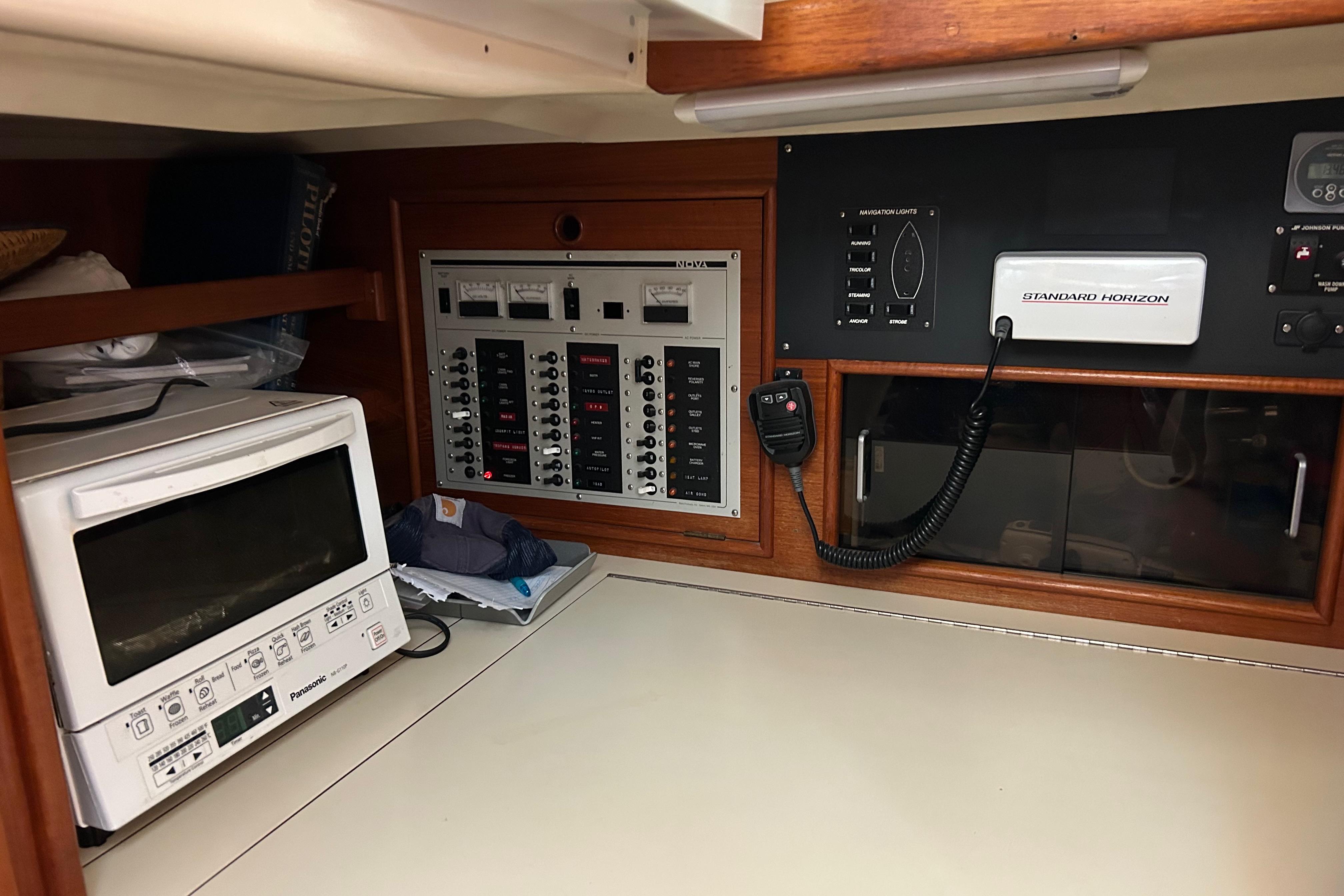 Control panel and microwave in 1989 Hinterhoeller Nonsuch 36 yacht interior.
