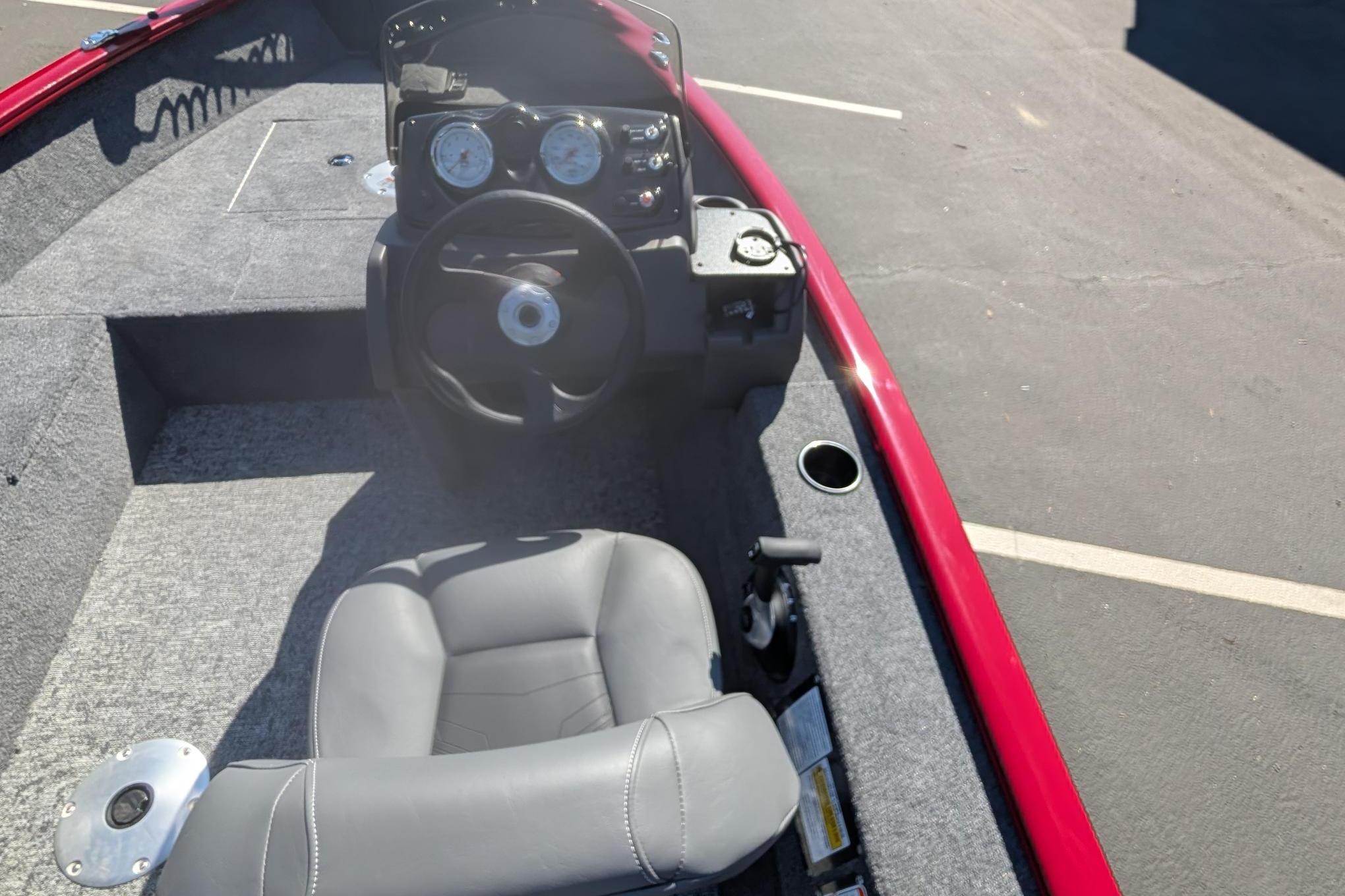 2026 Tracker Super Guide V-16 SC boat interior with steering wheel and seat.
