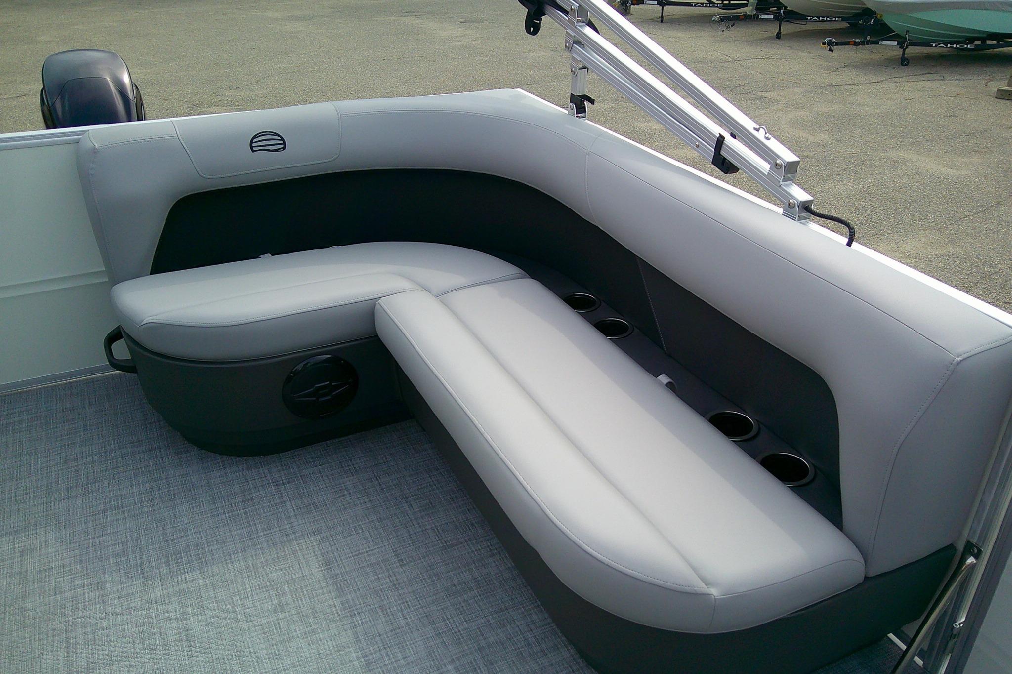 2026 Sun Tracker Party Barge 16 DLX interior seating with cup holders, gray upholstery.