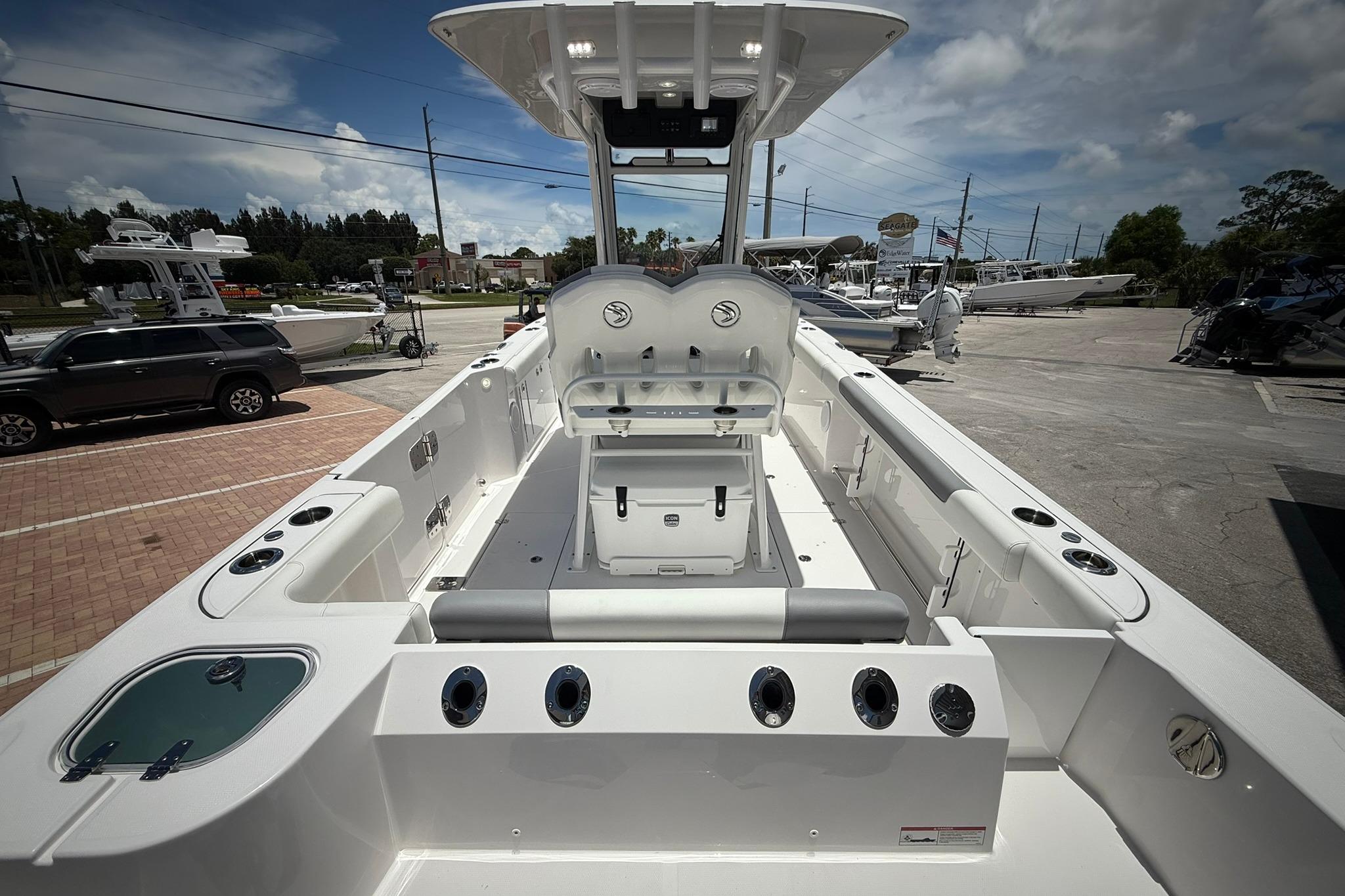 2026 Edgewater 250CC boat interior with seating and rod holders, parked outdoors.