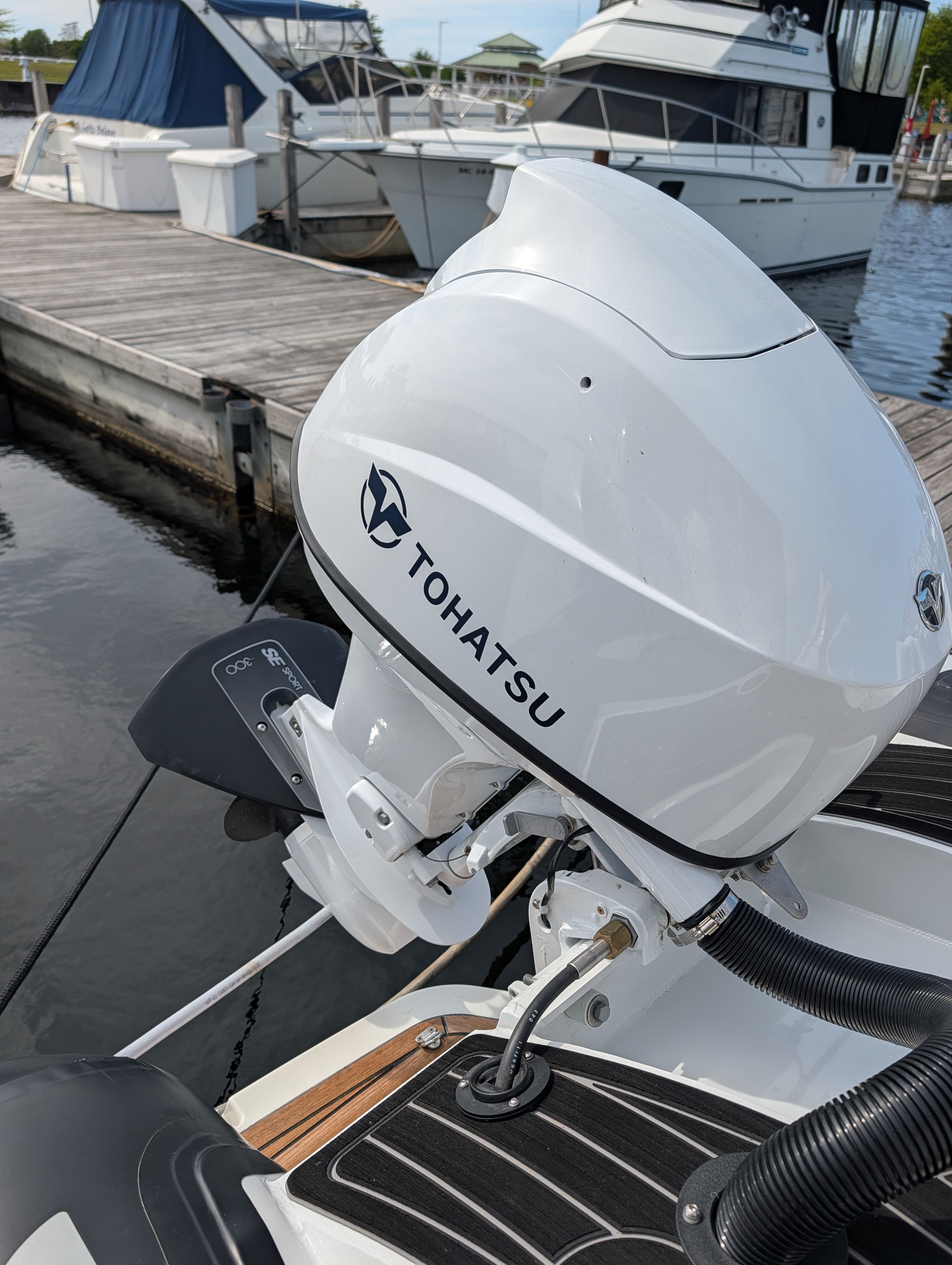 2024 Highfield Sport 390 with Tohatsu outboard motor at dock.