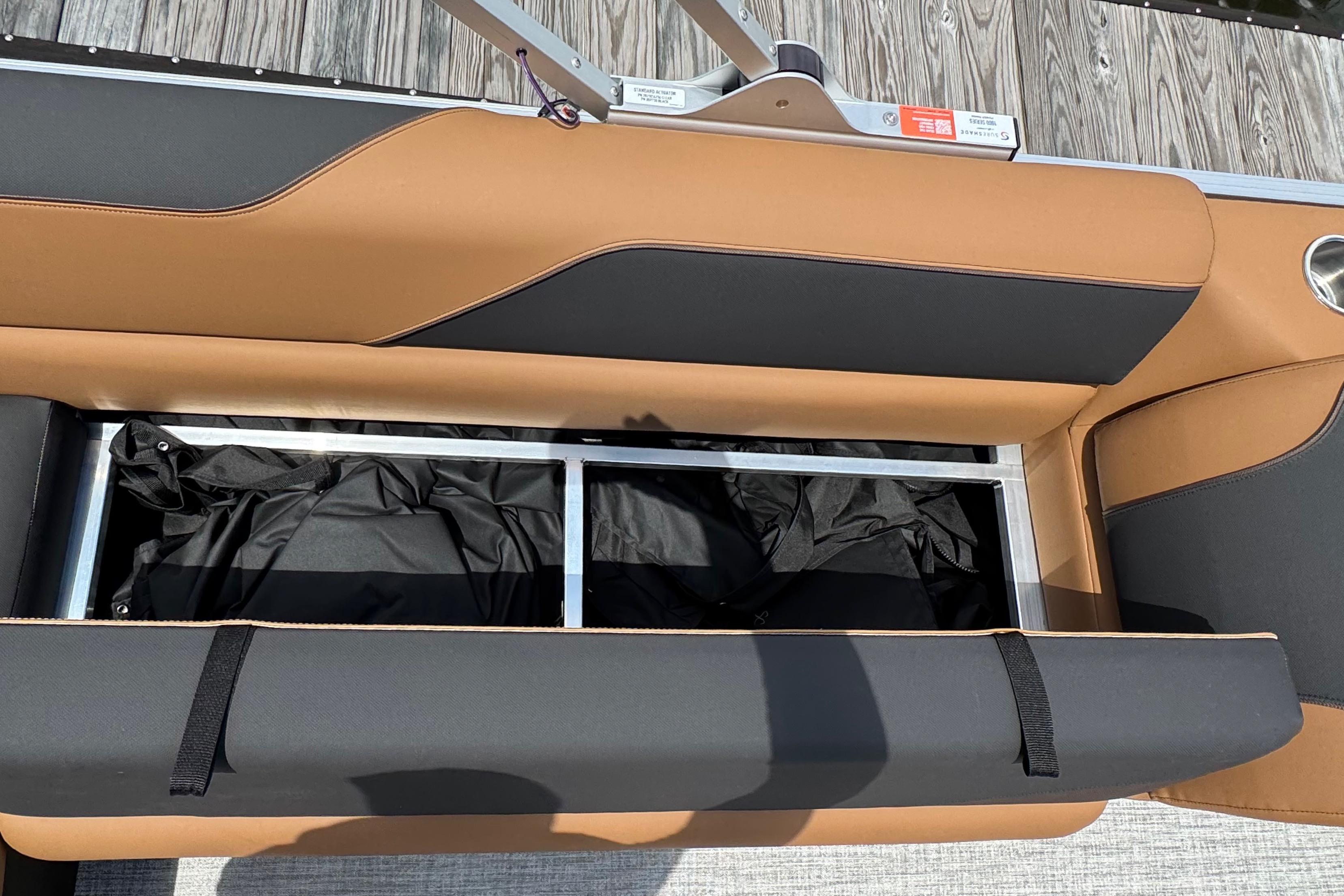 2026 Tahoe Pontoon Sport 85 Cruise Rear Bench storage compartment, open with black interior.
