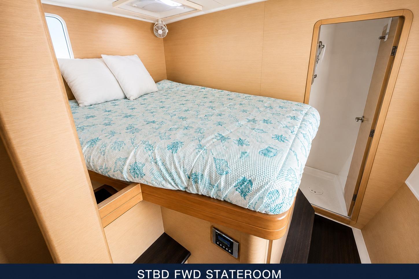 Stateroom in 2010 Lagoon 421 yacht with cozy bed and ensuite bathroom.