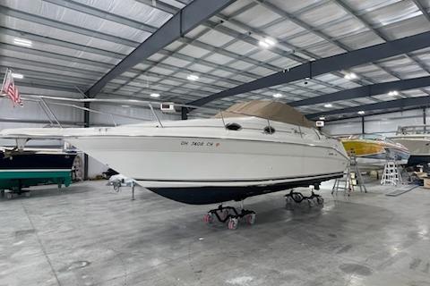 1998 Sea Ray 270 Sundancer boat in a spacious indoor storage facility.