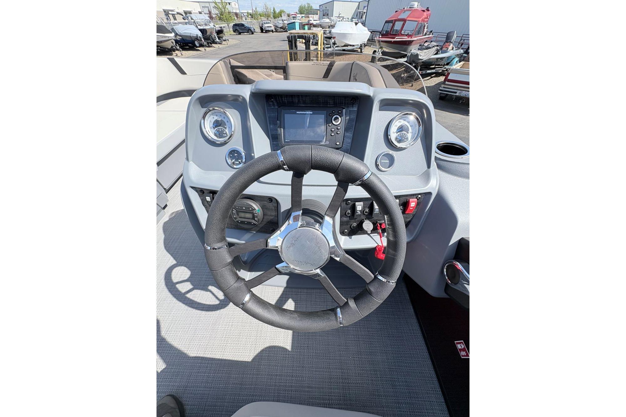 Steering console of 2026 SunChaser Lucerne 22 LR DH boat with modern controls.