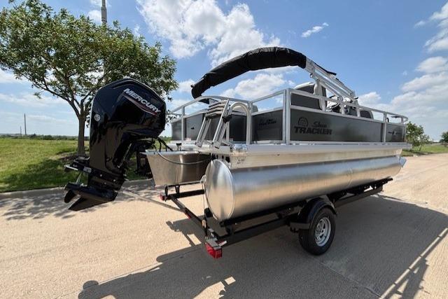 2026 Sun Tracker Bass Buggy 18 DLX pontoon boat on trailer, with Mercury outboard motor.