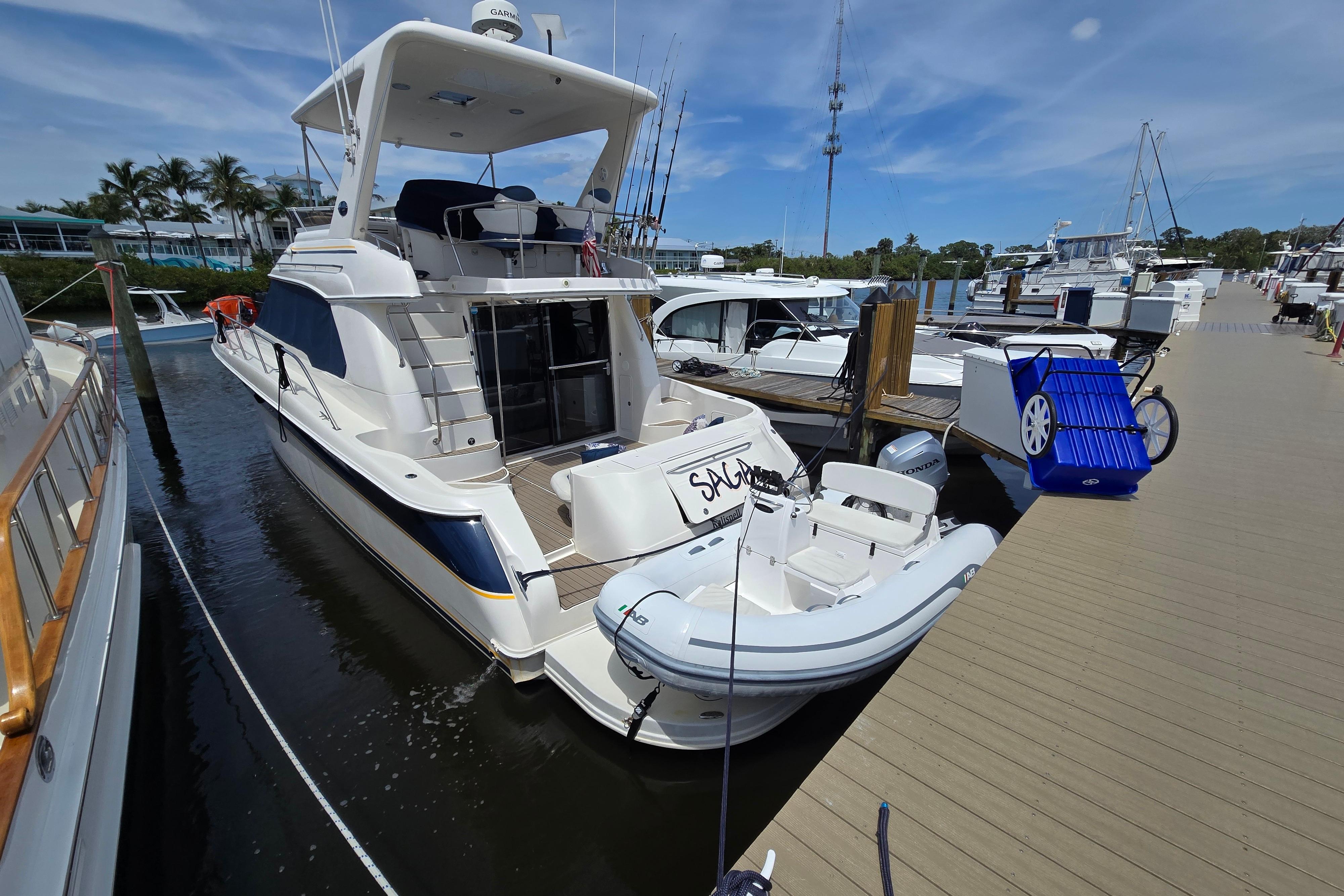 Luxury yacht AB 11 VSX 2023 docked at marina with inflatable boat.