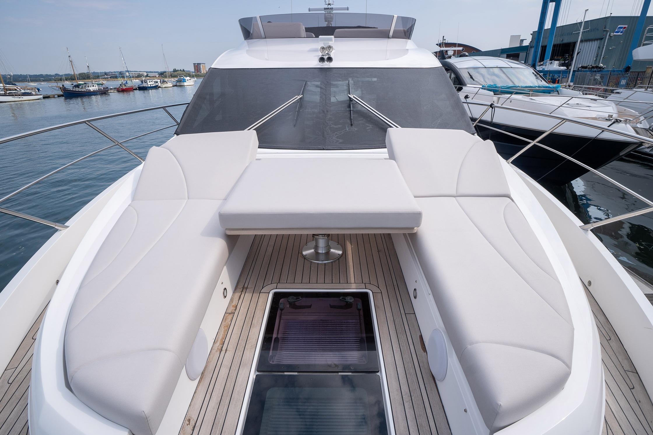 2024 Sunseeker Manhattan 55 yacht with spacious deck and luxurious seating at marina.