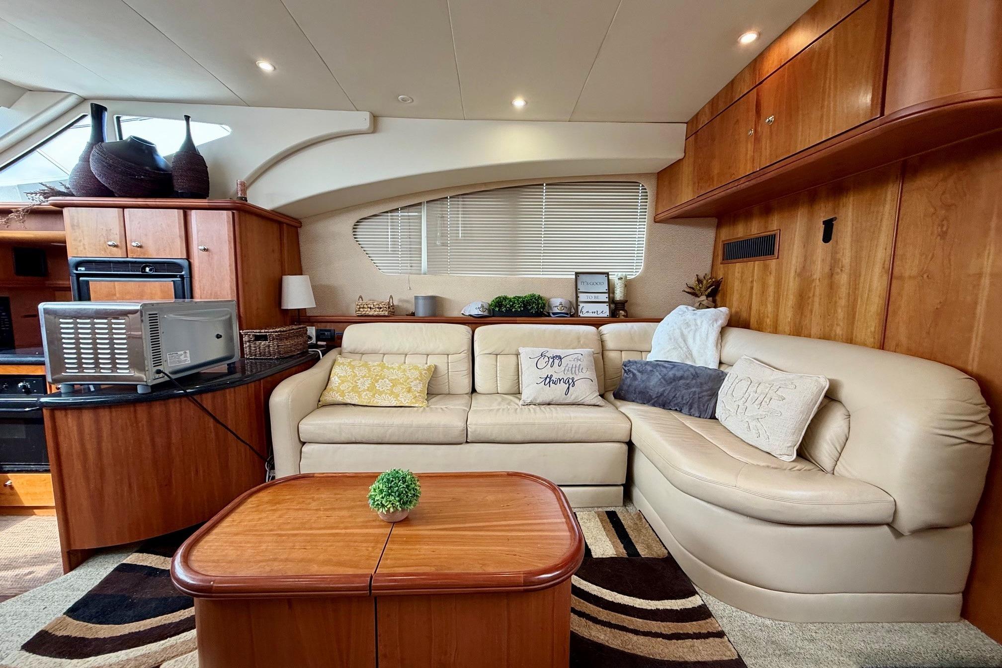 Luxurious interior of 2004 Silverton 39 Motor Yacht with plush seating and elegant decor.