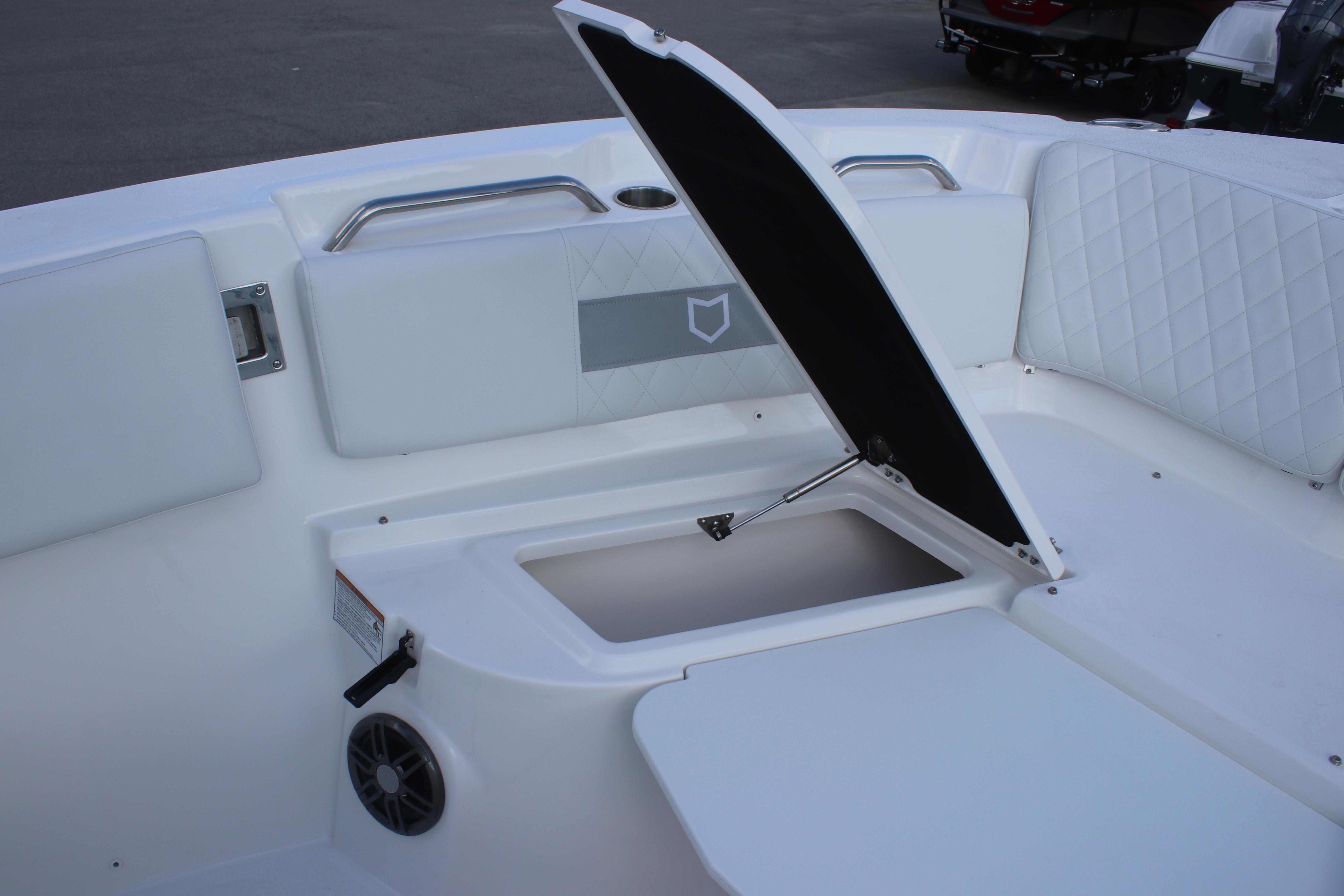 2026 Sea Fox 268 Commander boat interior with open storage compartment and cushioned seating.