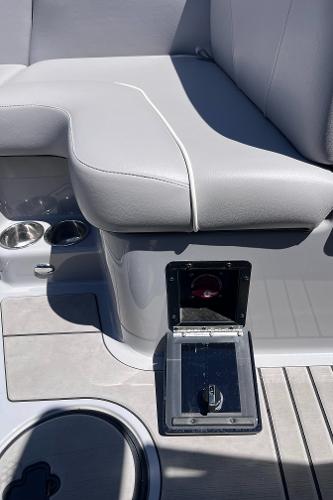 2024 Moomba Max boat interior with gray seating and storage compartment.