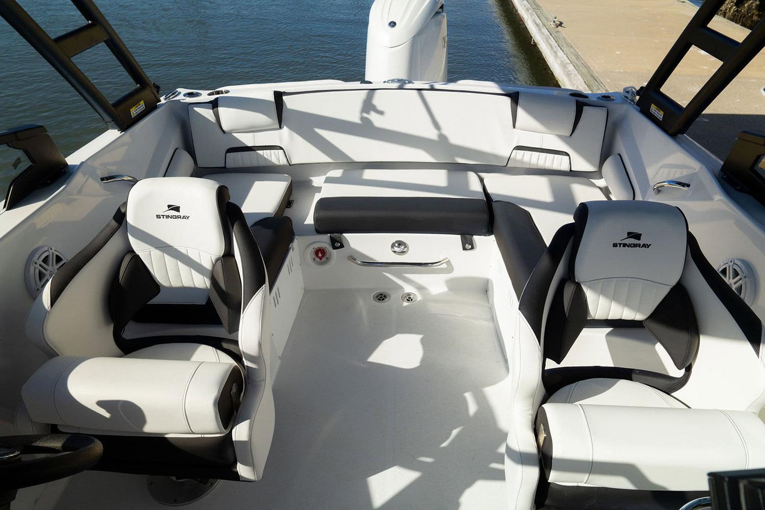 Manufacturer Provided Image: 2026 Stingray 20 SBX boat interior with white and black seating, dockside view.