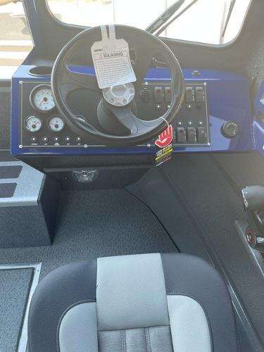 Interior of 2025 Spartan 240 Maximus Pro, featuring steering wheel and control panel.