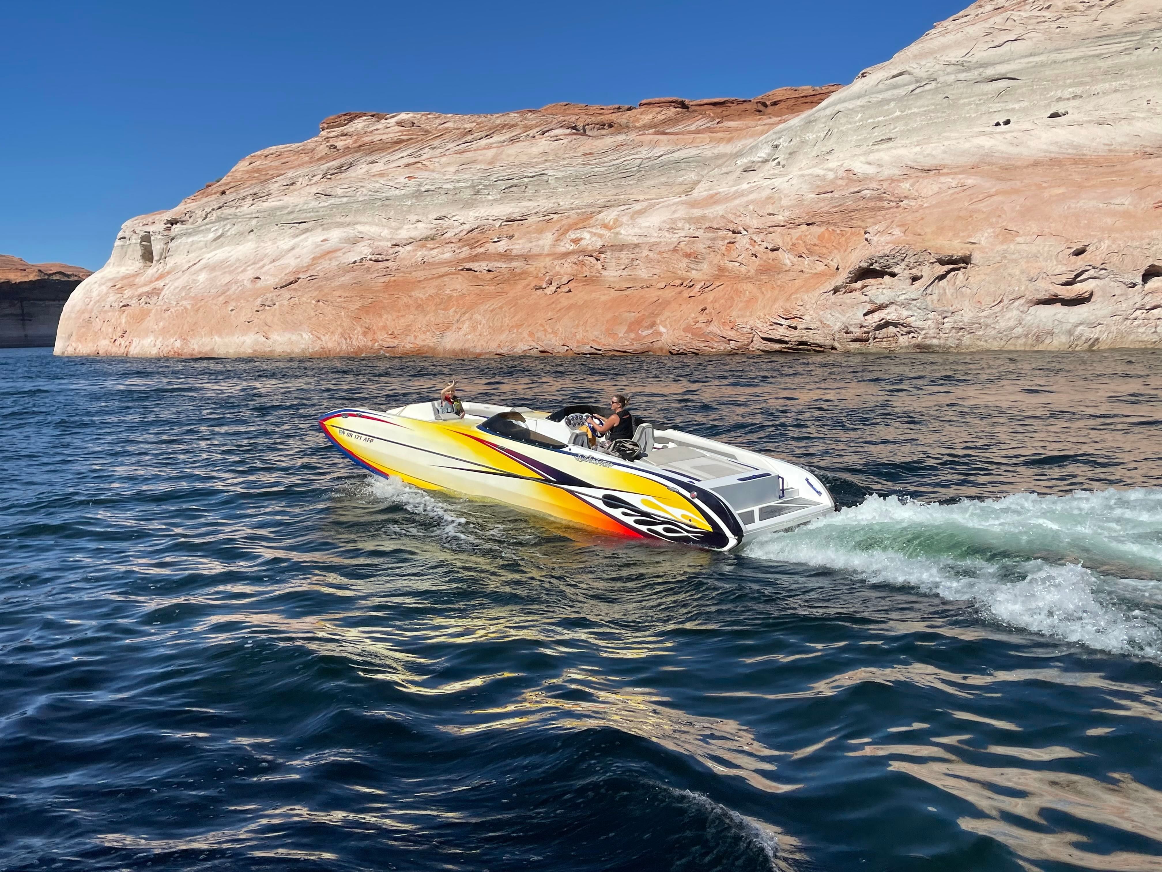 A 2016 Interceptor CoolCat cruising on a lake with rocky shores.