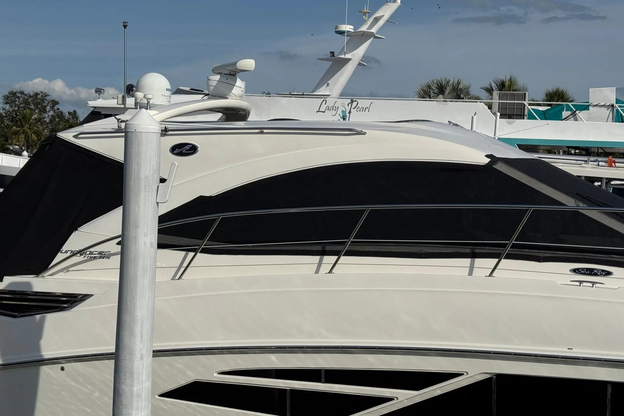 2016 Sea Ray Sundancer 510 yacht docked at marina, side view.
