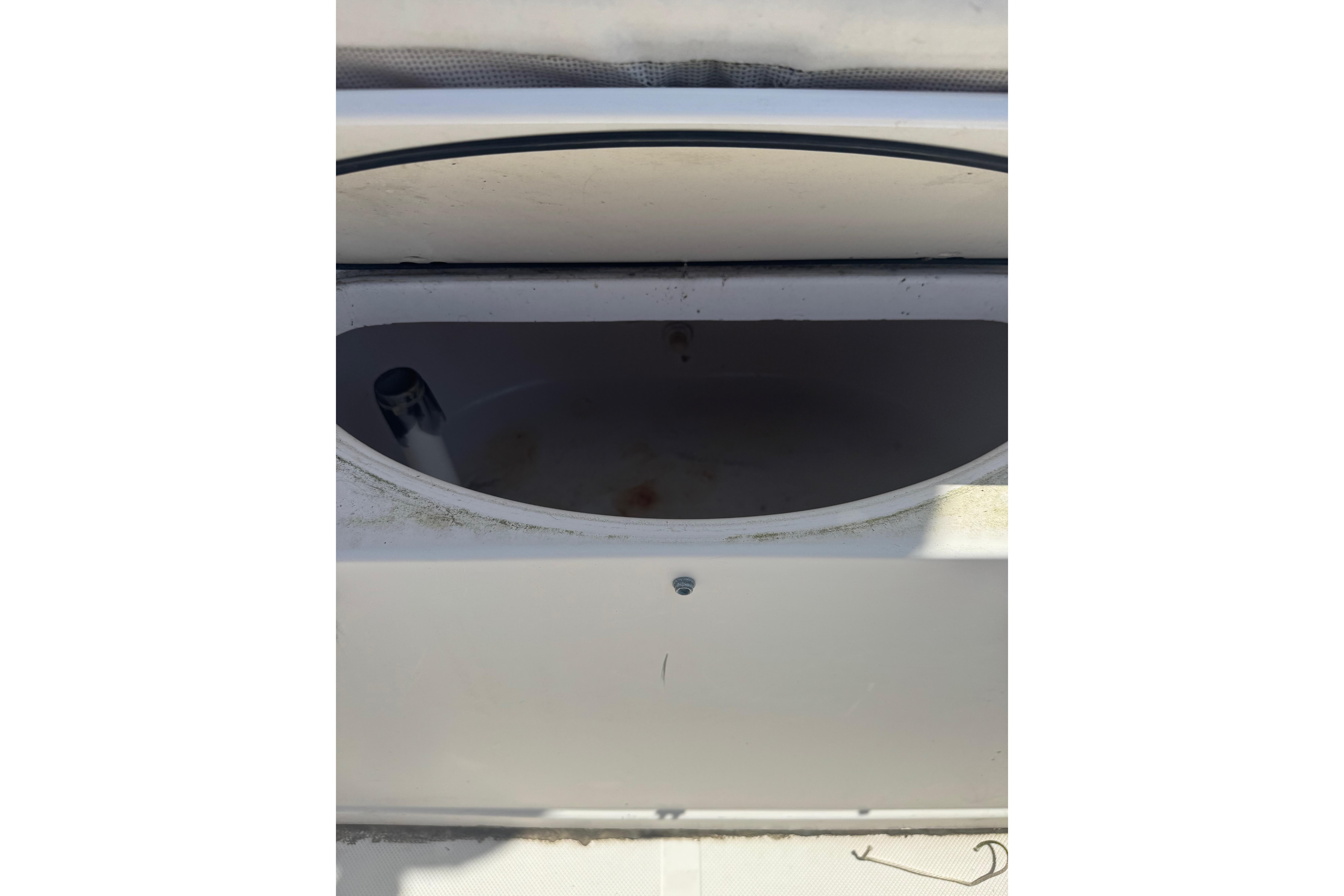 Livewell compartment on a 2002 Pro-Line 23 Sport boat, partially open.