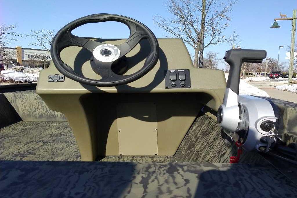 2026 Tracker Grizzly 1648 SC boat steering console with control panel and throttle.