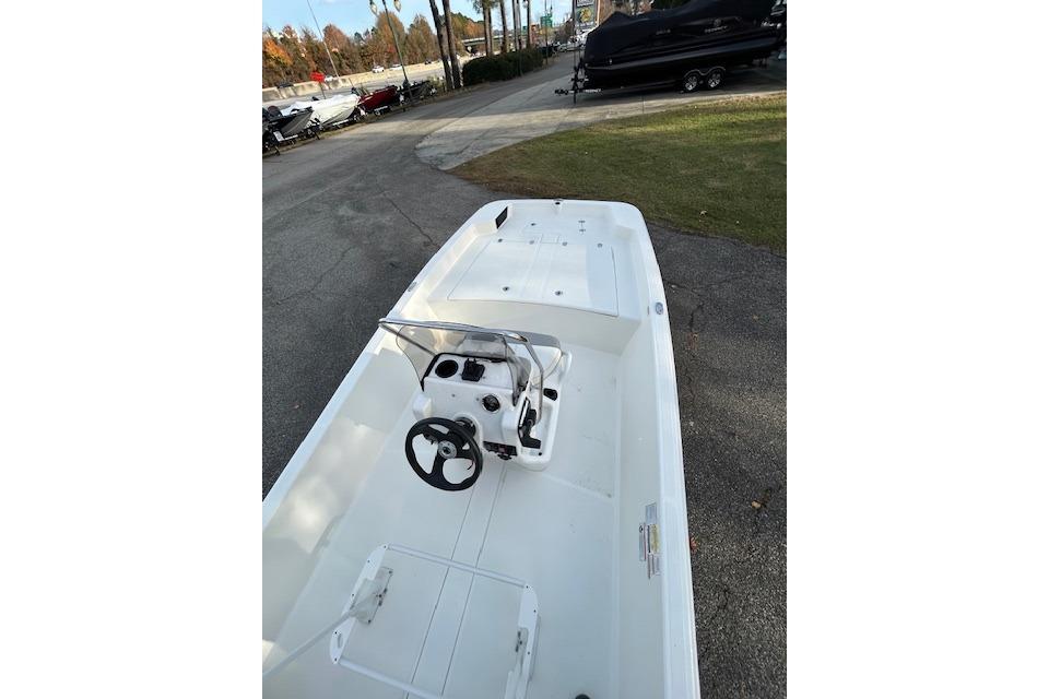 2025 Mako Pro Skiff 17 CC boat with center console, parked outdoors.