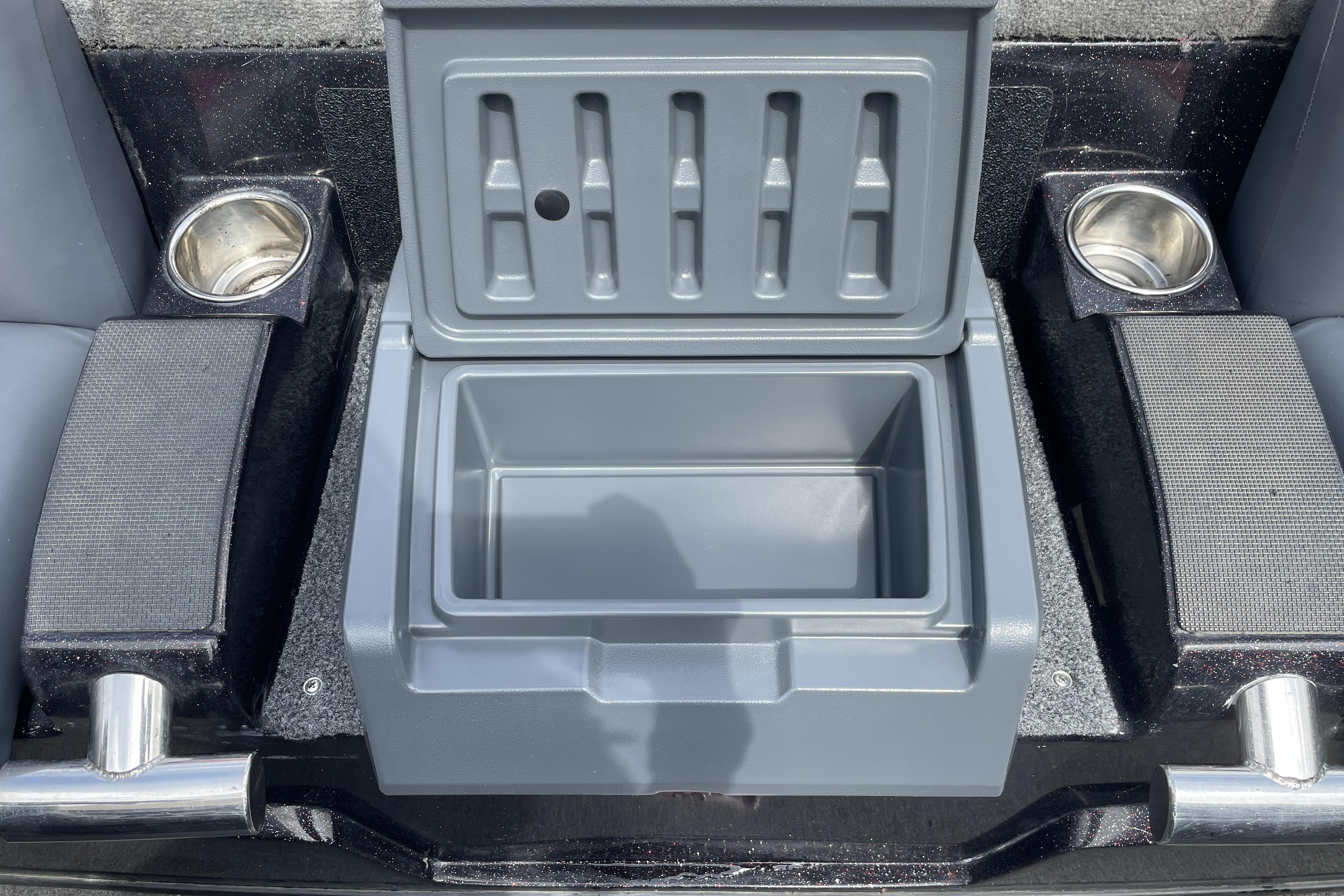 Open storage compartment in 2013 Nitro Z-8 boat with cup holders and armrests.